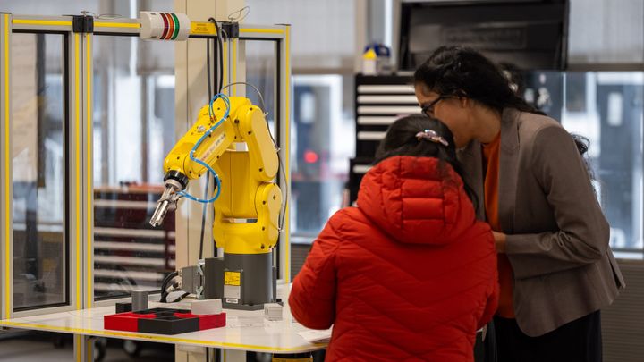 Two women look at a machine in the new Advanced Manufacturing Hub