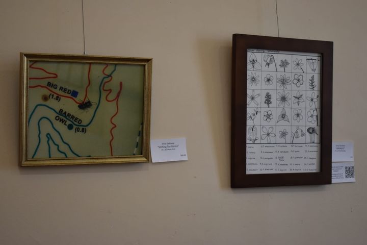 Two pieces hang on a wall of the Oxford Community Arts Center