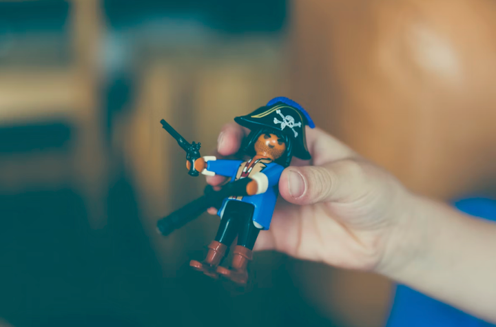 Person holding a plastic pirate toy