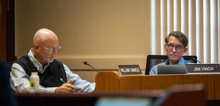 Councilors Bill Snavely (left) and Jim Vinch listen to public discussion