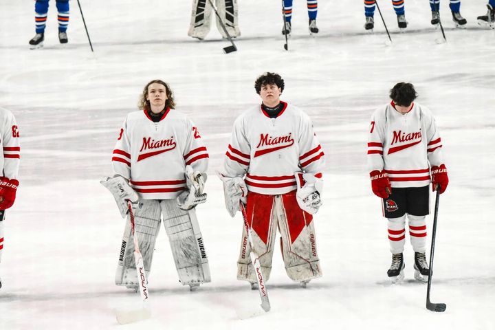 Andy Page (middle) at the Goggin Ice Center next to a fellow goaltender