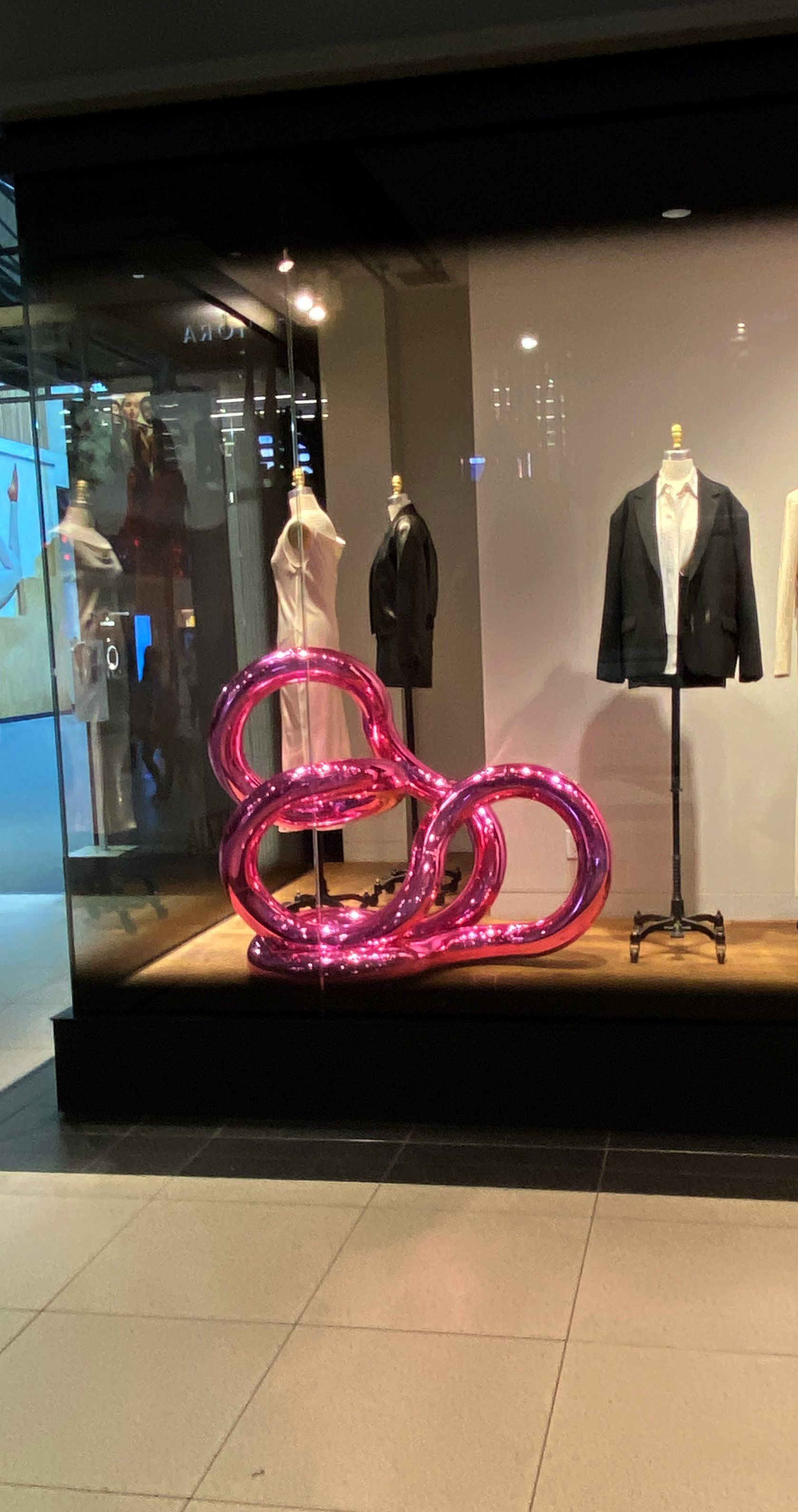 Large fuchsia Tangle in a clothing store window.