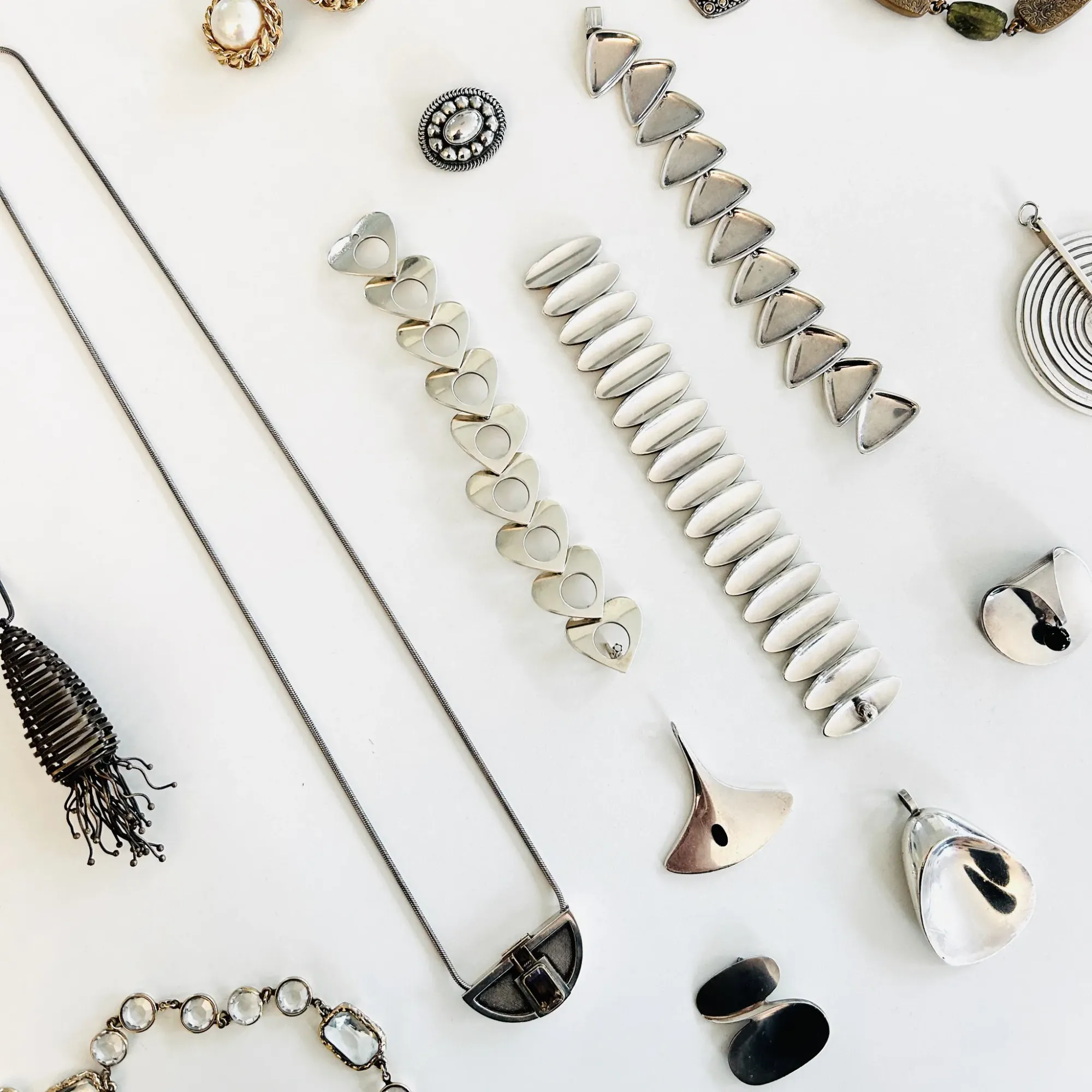 Scandinavian and vintage jewelry resting on a white tabletop.