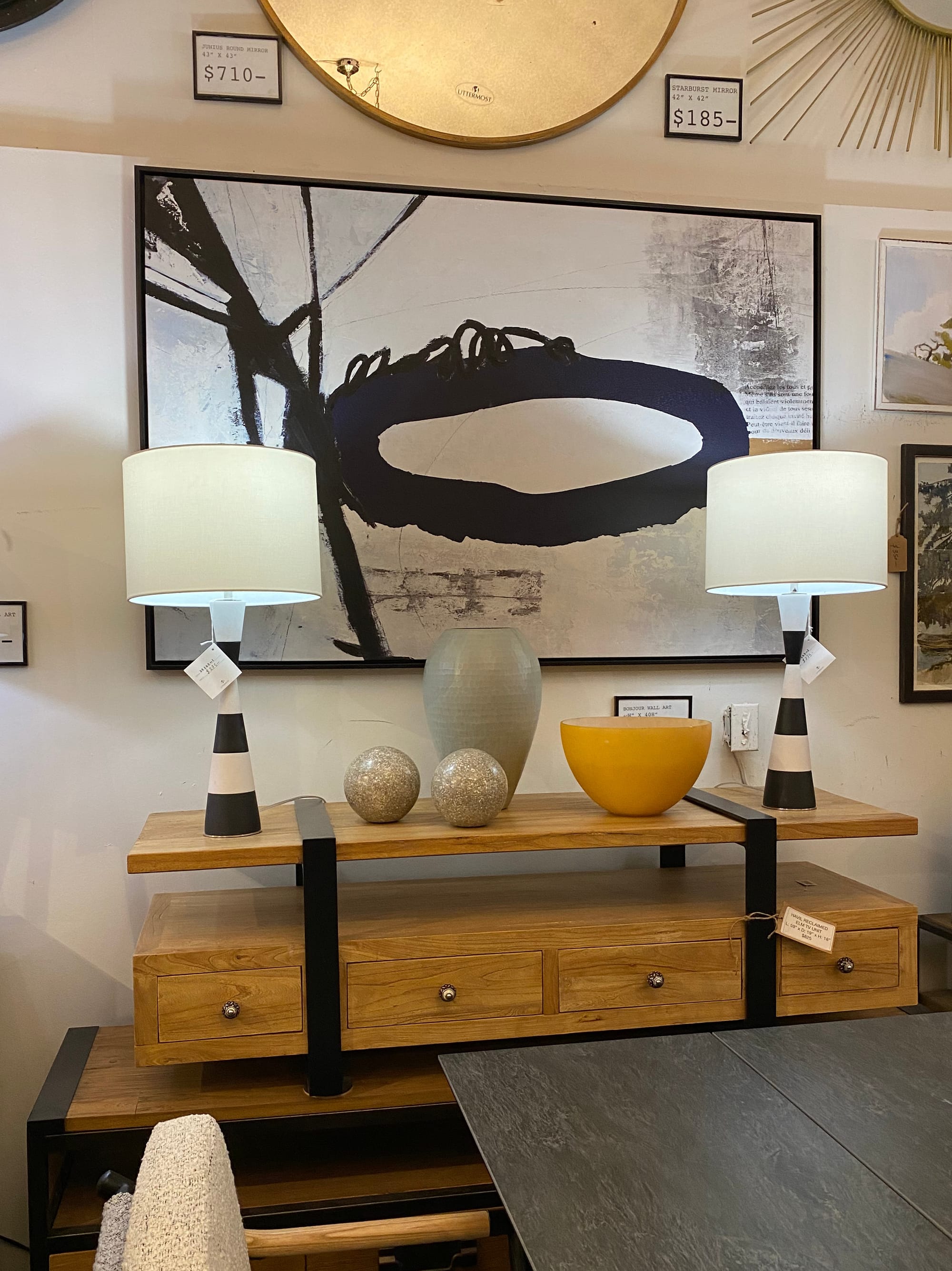 Furniture store vignette with two table lamps on a credenza, one on each end.