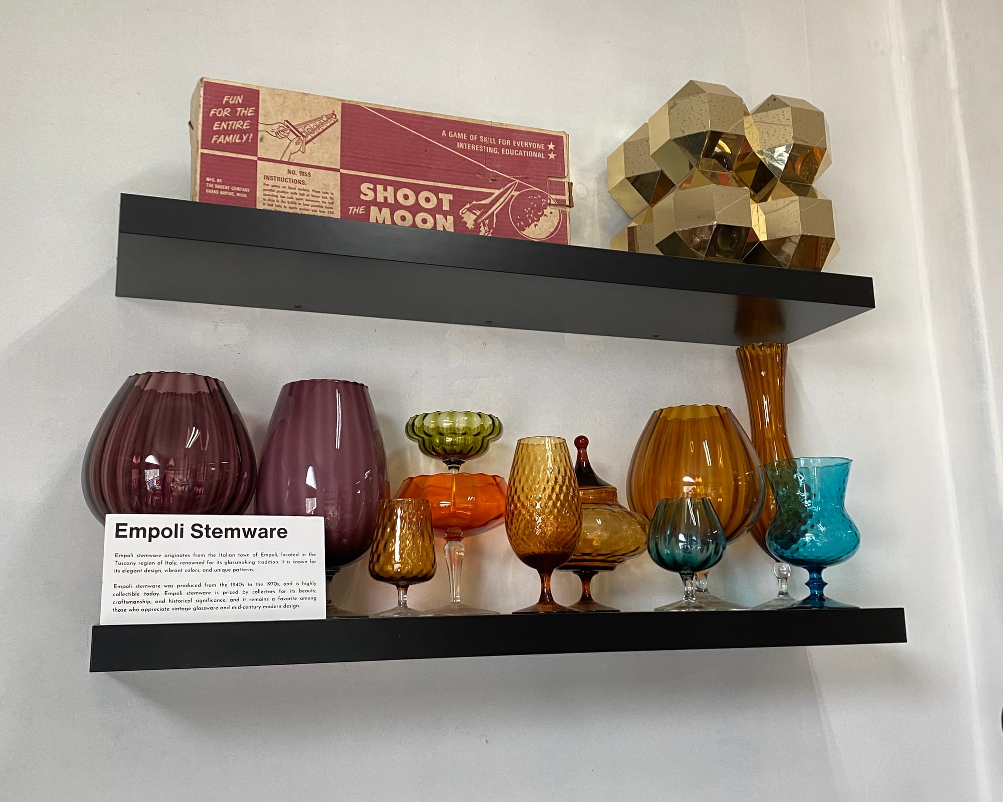 Empoli glassware on a shelf.