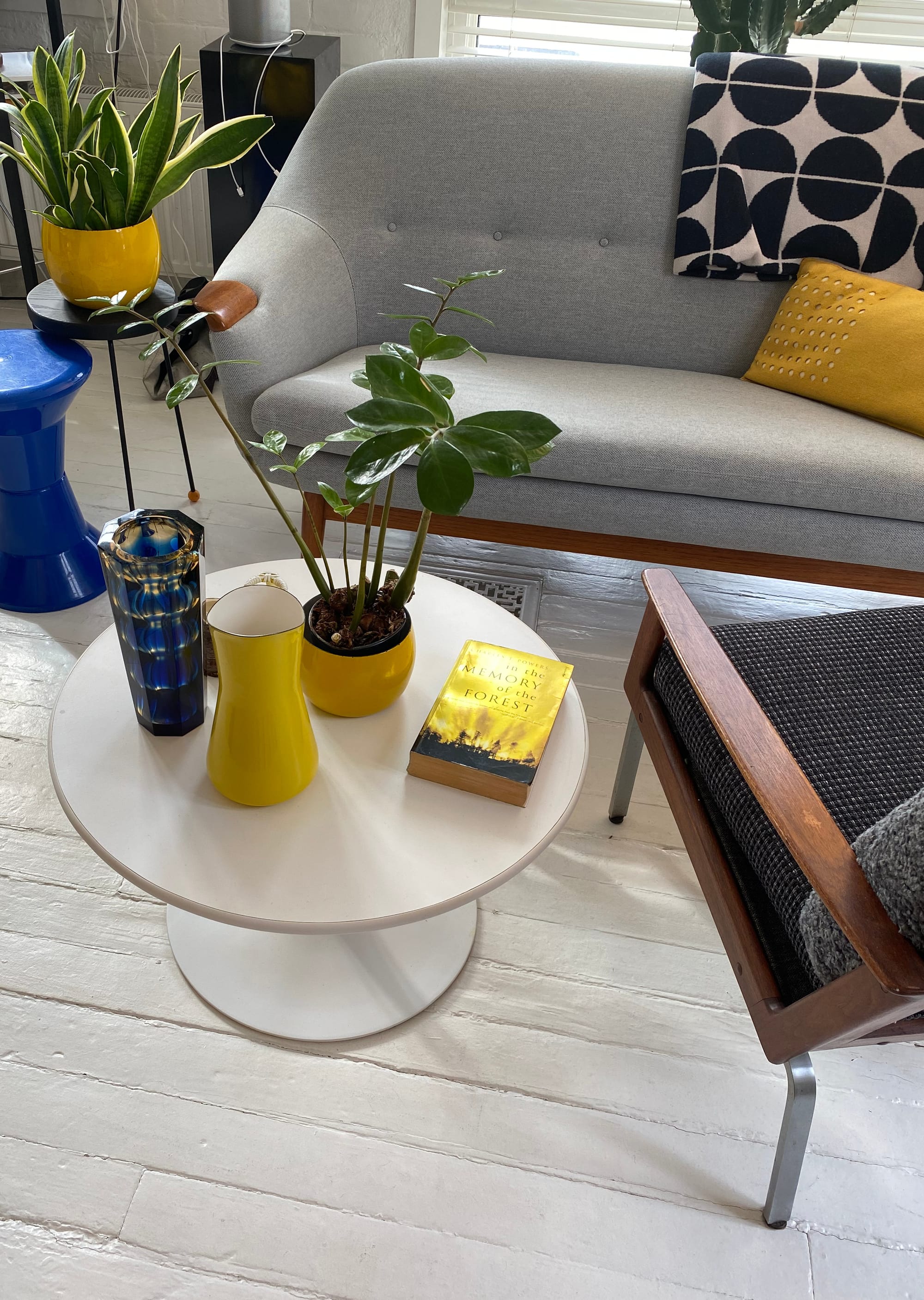 Mid-century sofa and side chair, along with a coffee table displaying an assortment of things.