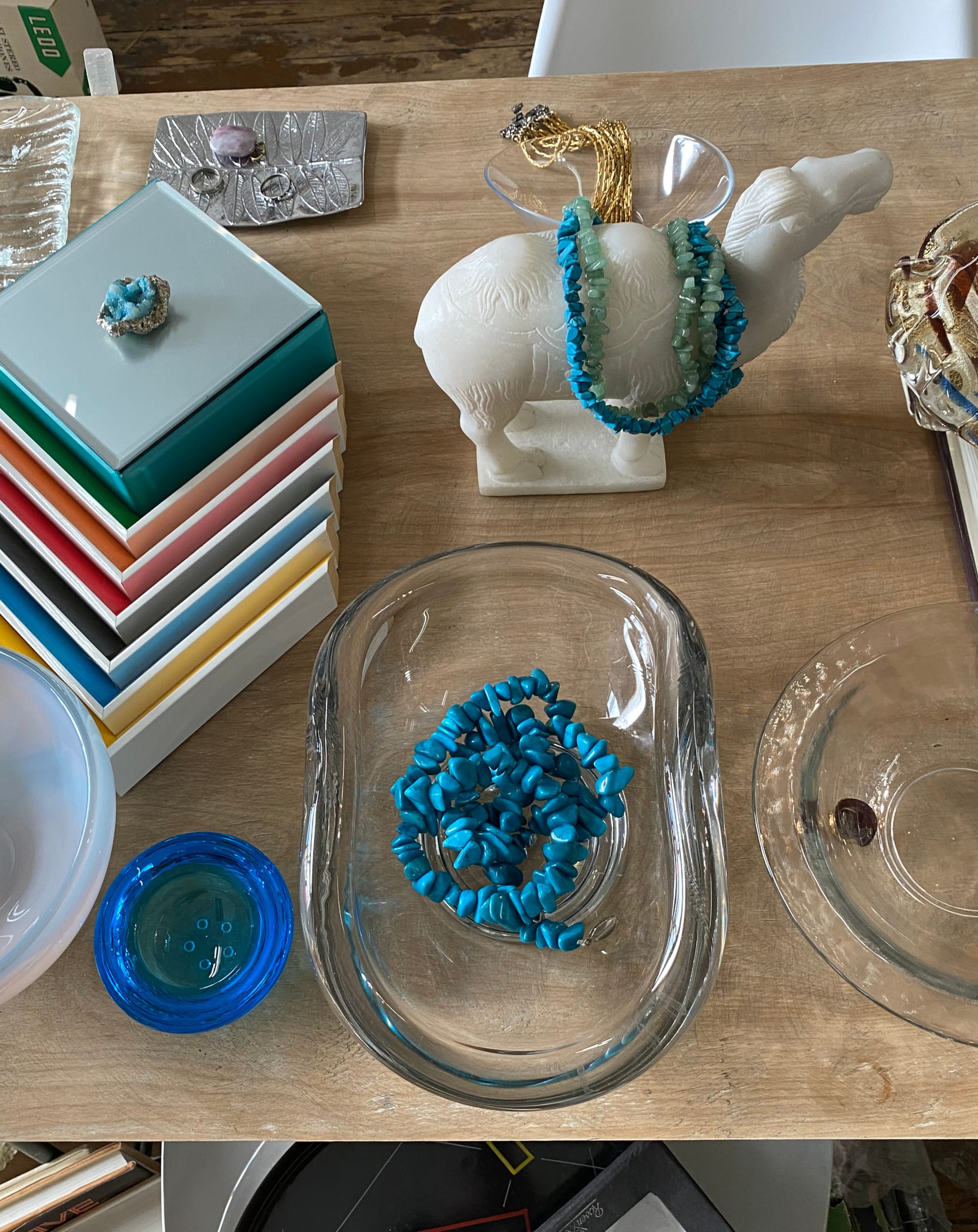 Necklaces and rings arranged with small decorative objects.