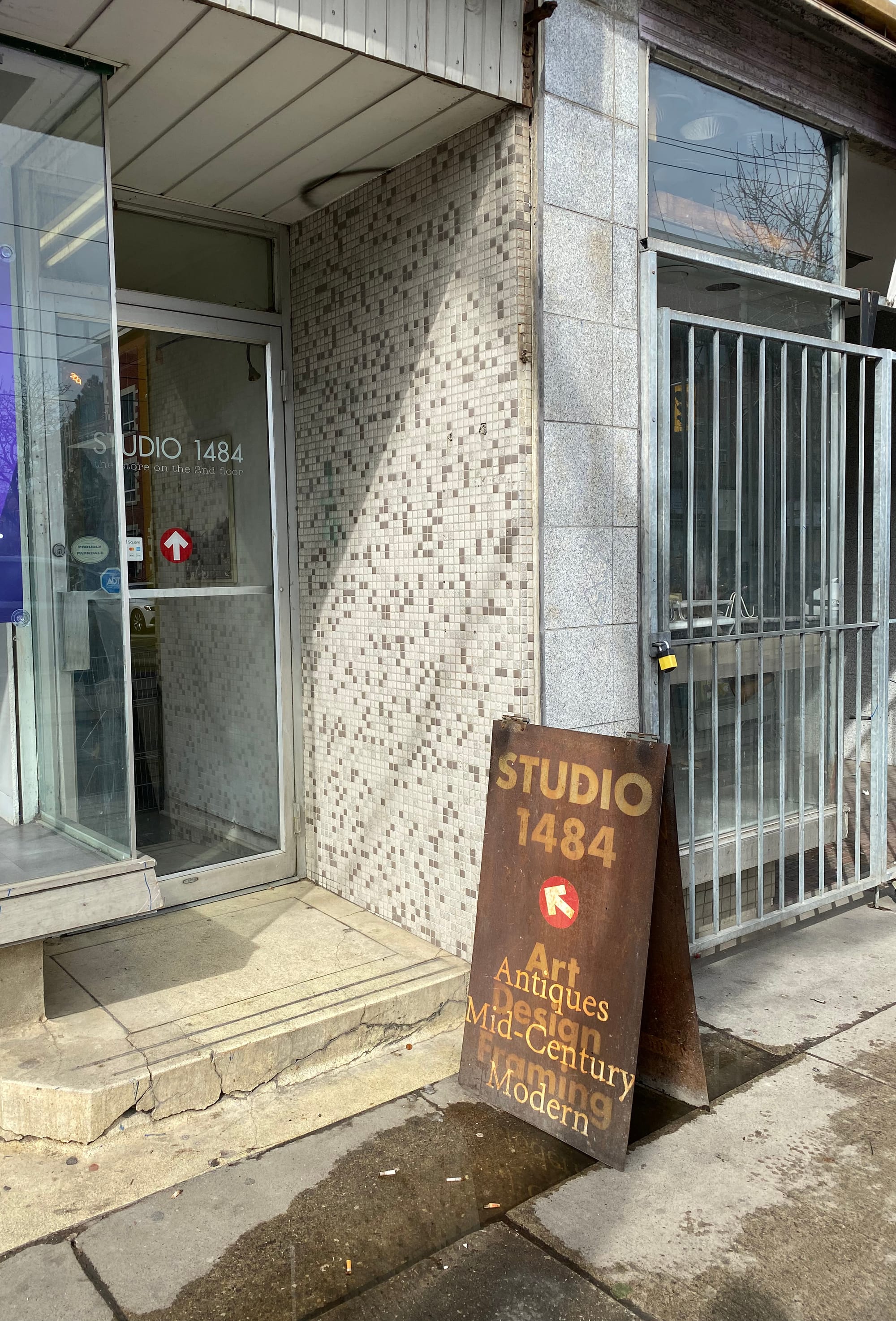 Rusty Studio 1484 signboard in front of an entryway.