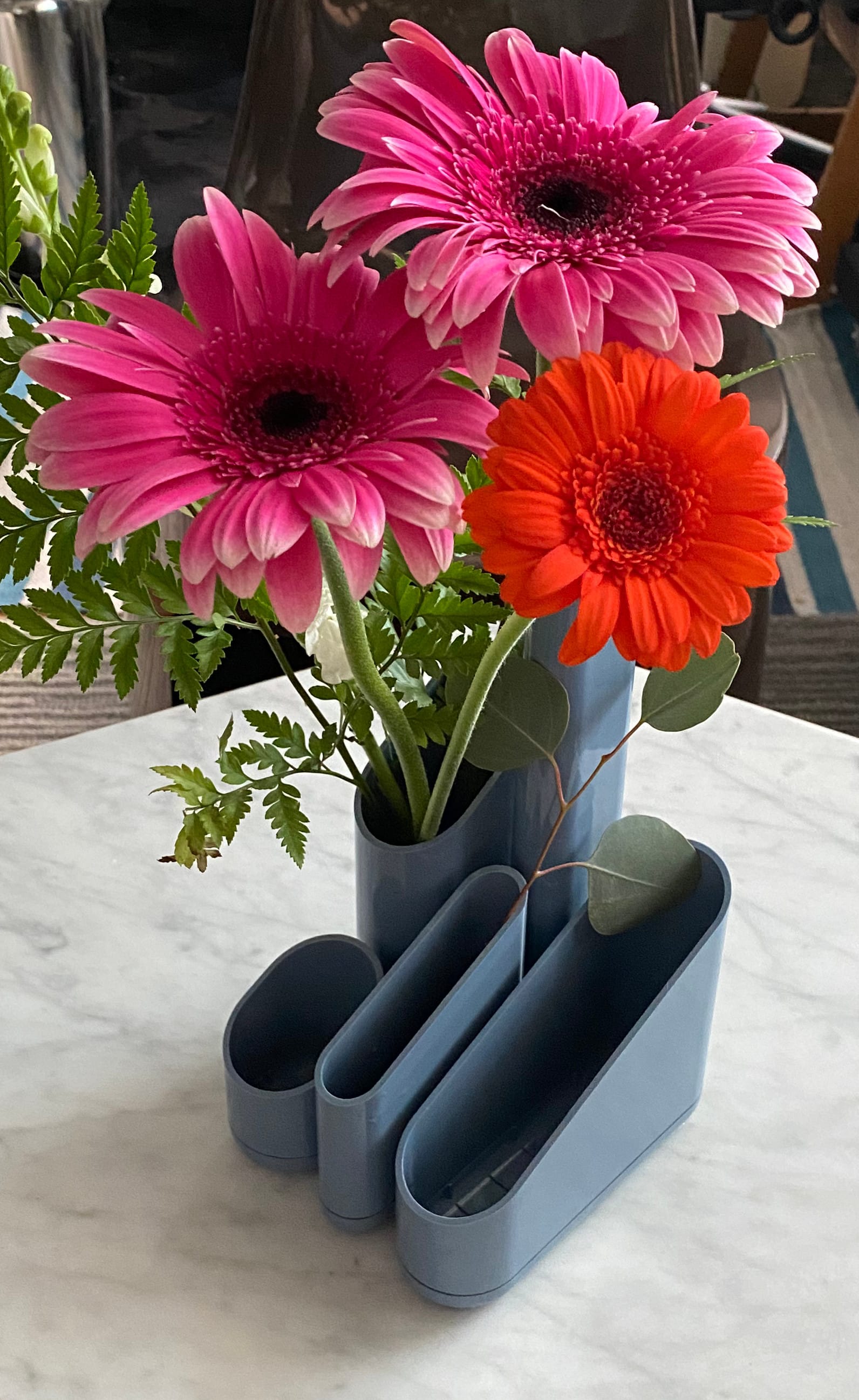 The same desk organizer holding three Gerbera daisies.