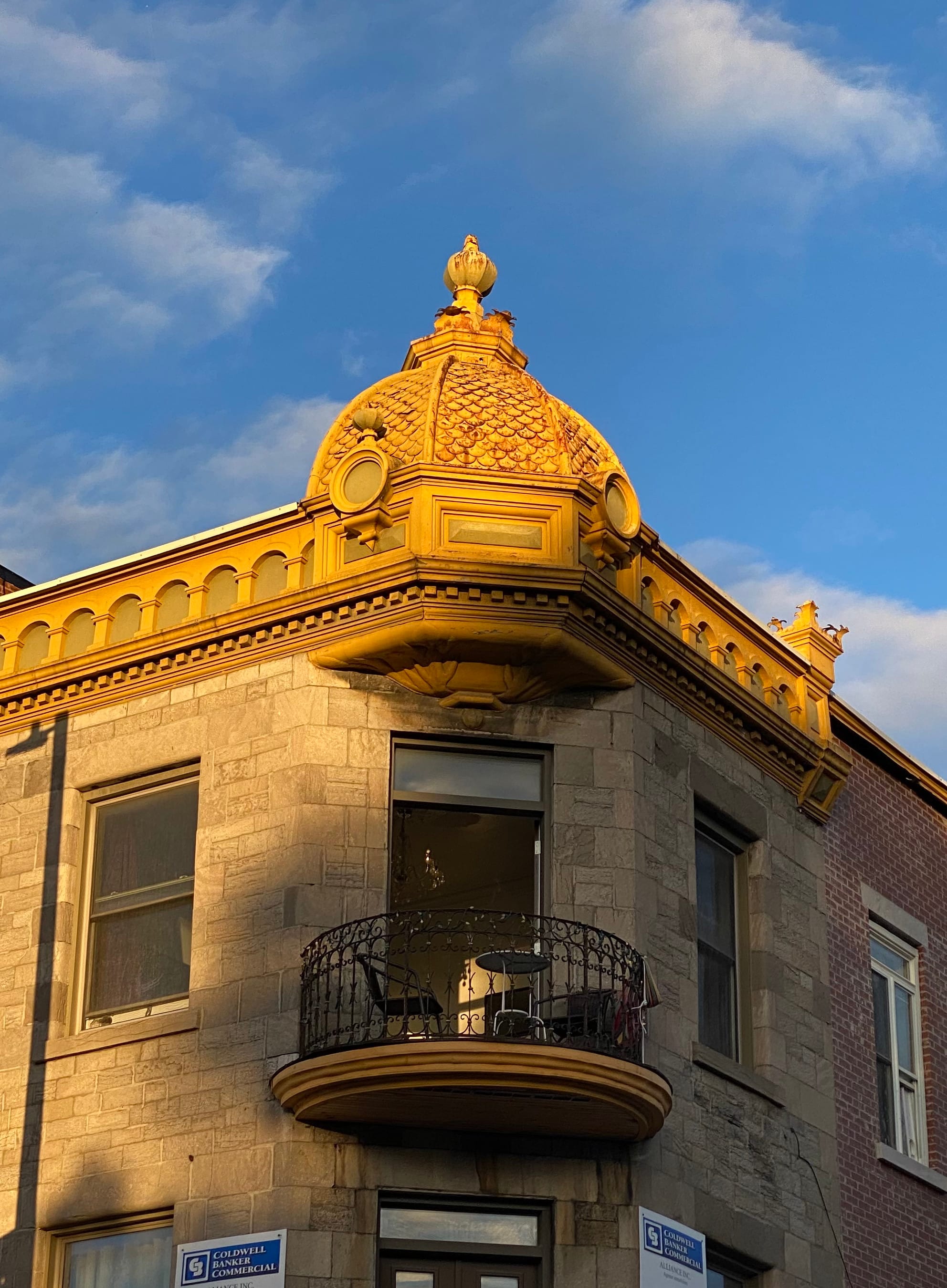 Apartment balcony at the top level of a historic Montreal building.