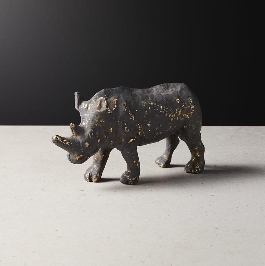 Brass rhino figurine with a weathered patina.