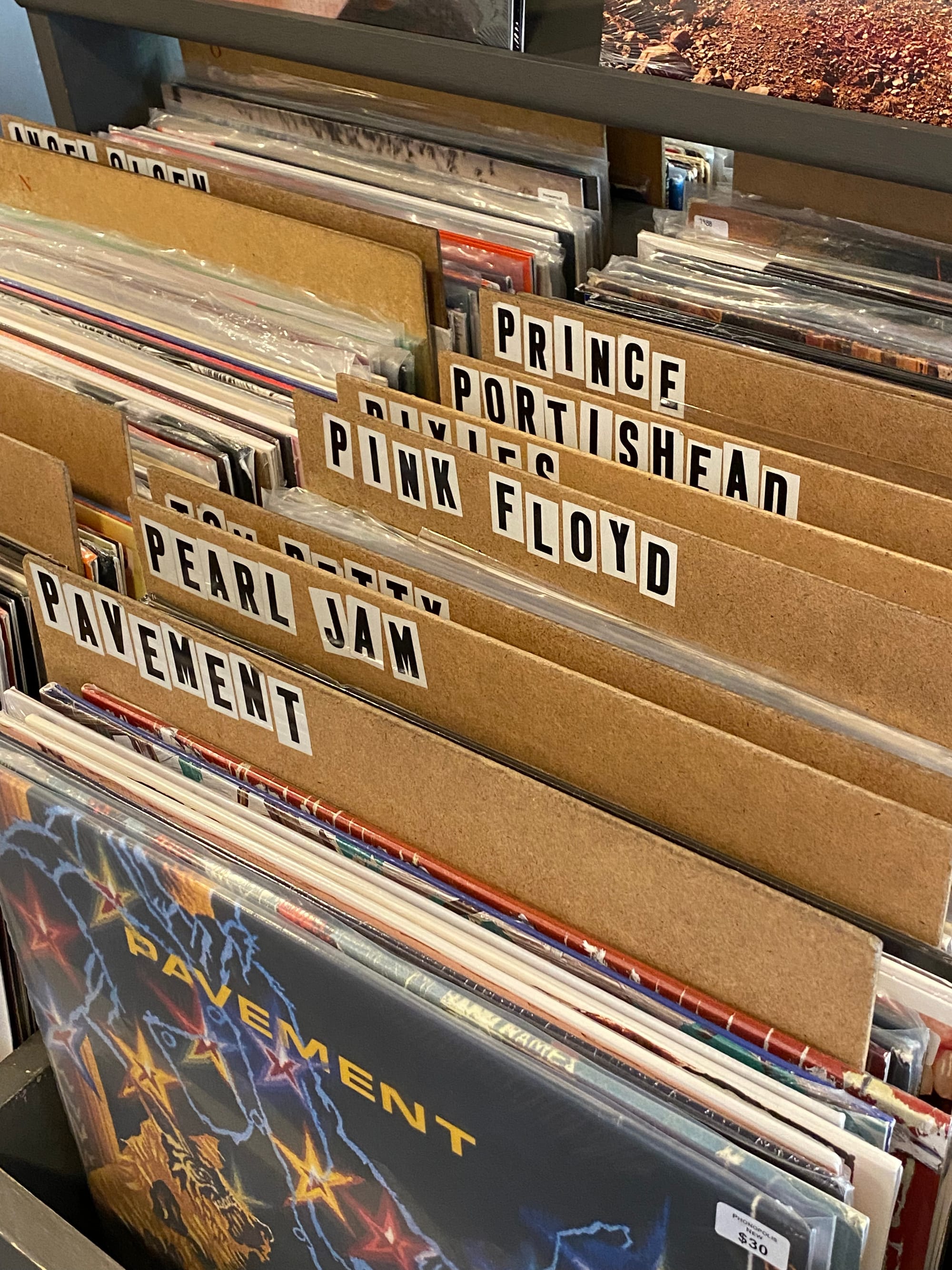 Record dividers with lettering composed of stickers that are unevenly placed.