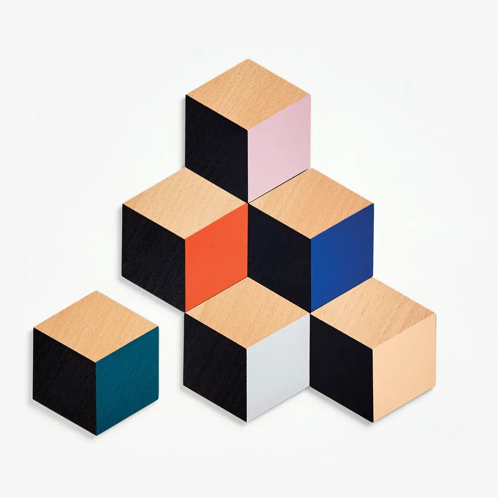 Six wooden coasters that fit together in a geometric pattern.