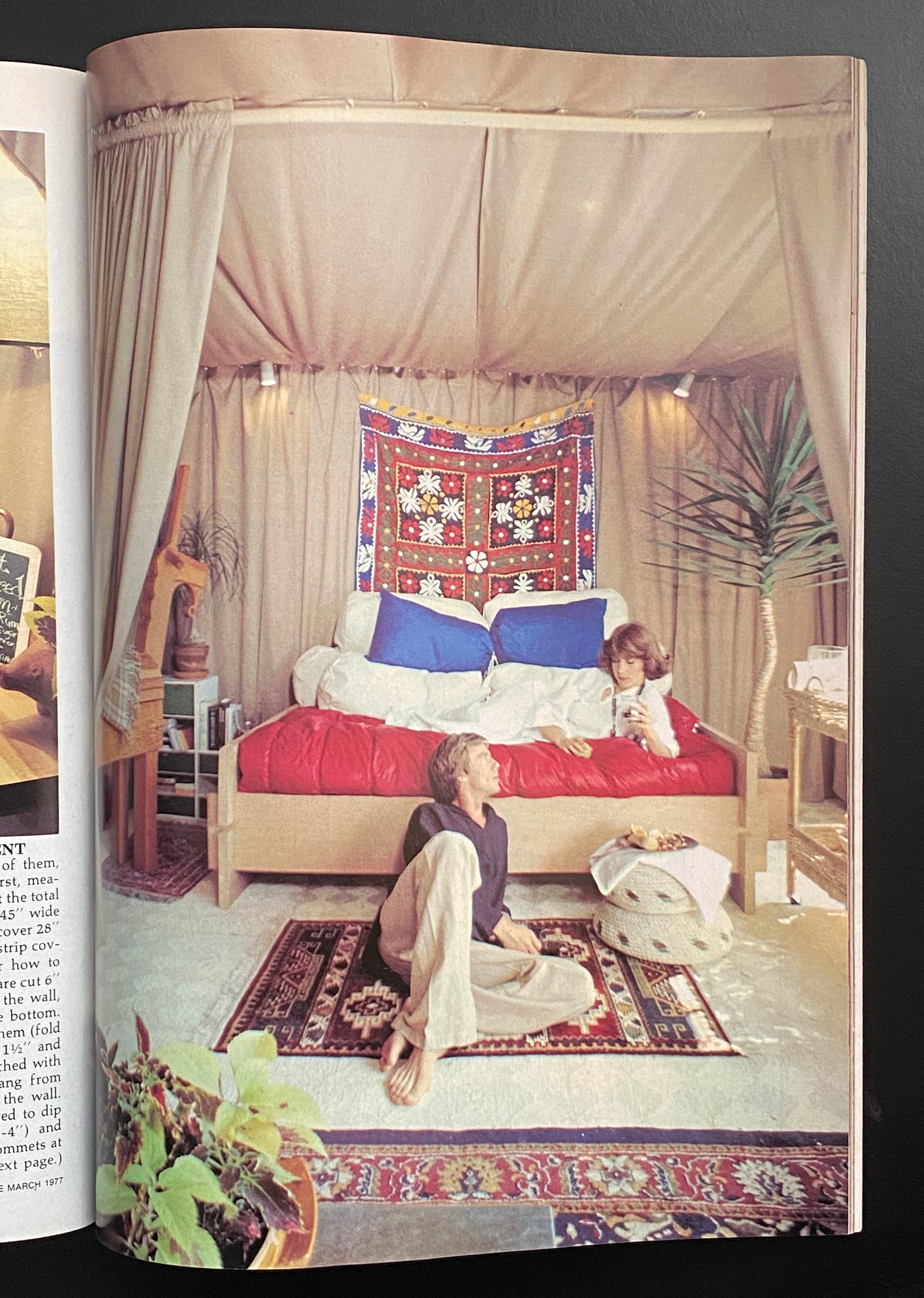 A couple lounging in a tent-apartment.