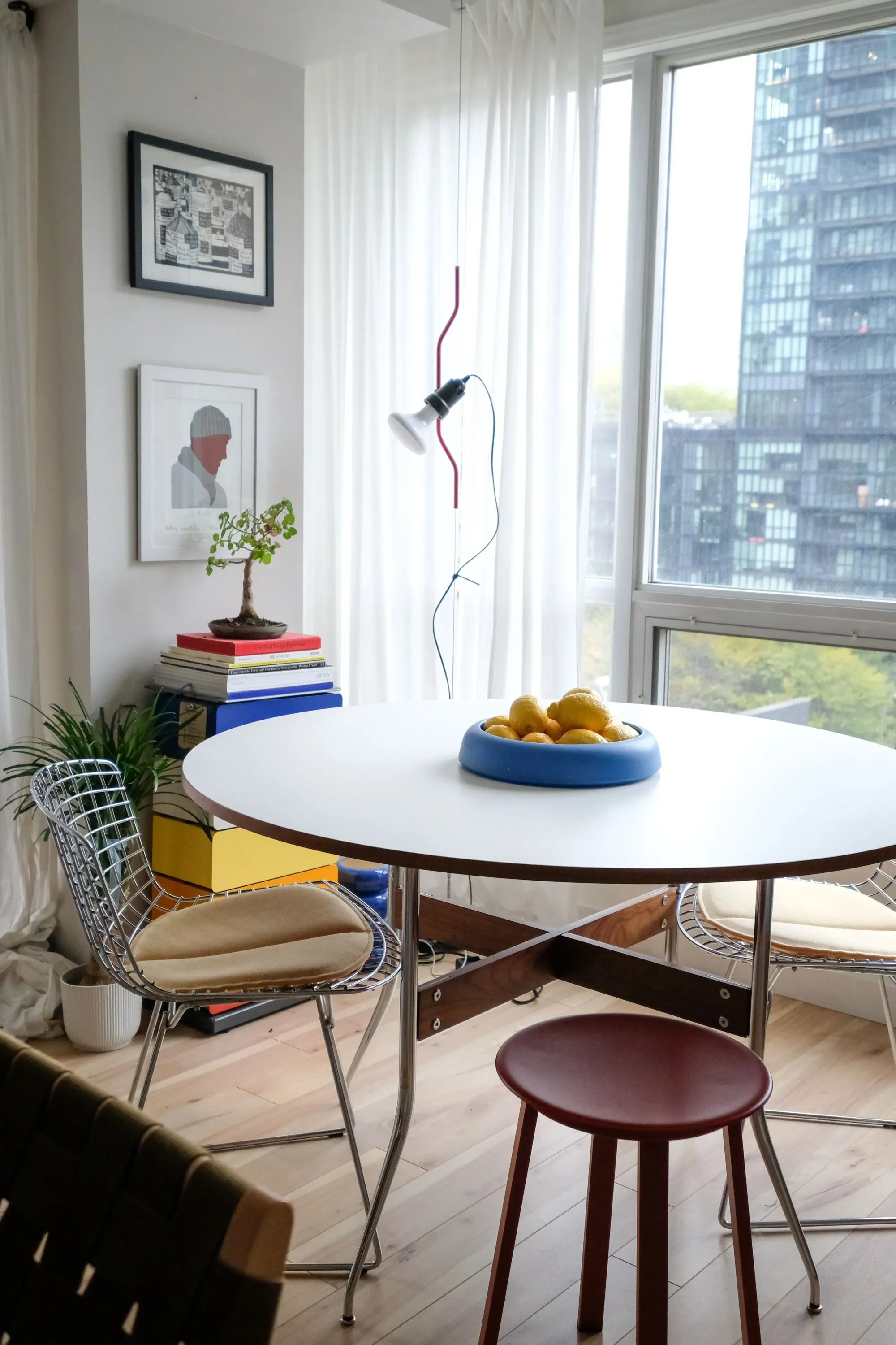 Dining room with mid-century furnishings and a red-yellow-blue colour scheme.