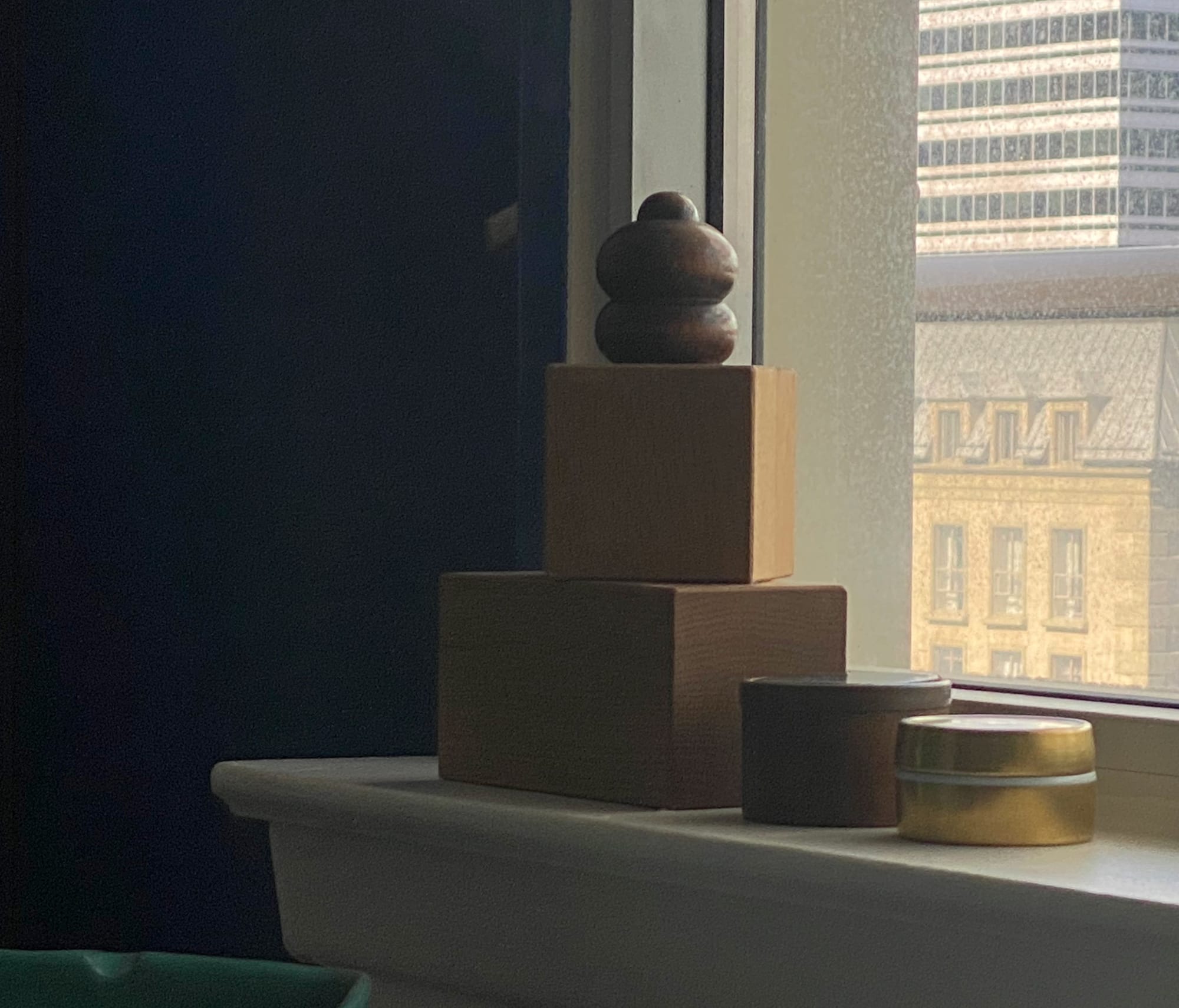 Wooden knob on top of two stacked blocks.