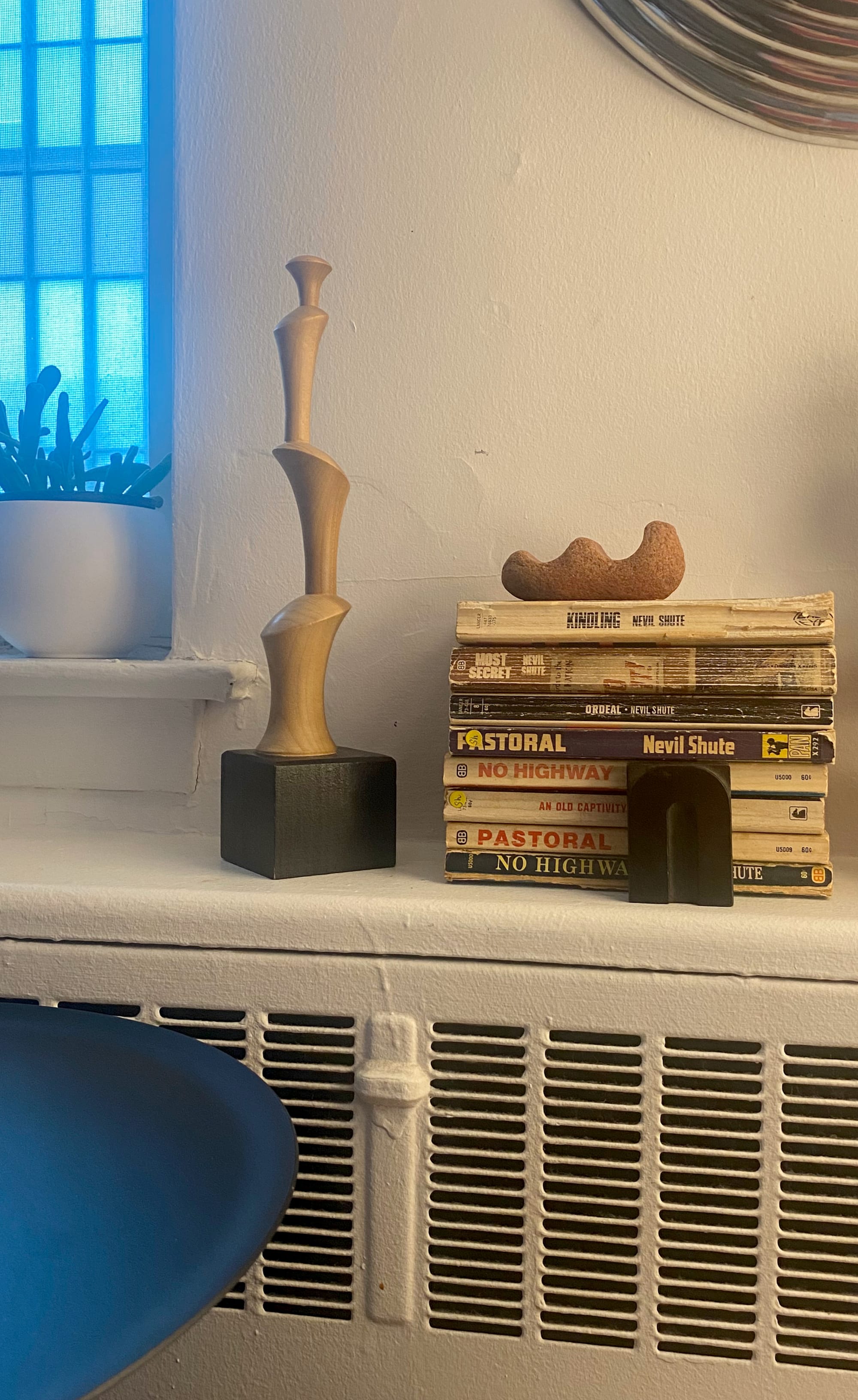 Poplar sculpture incorporated into a display on my living room radiator.