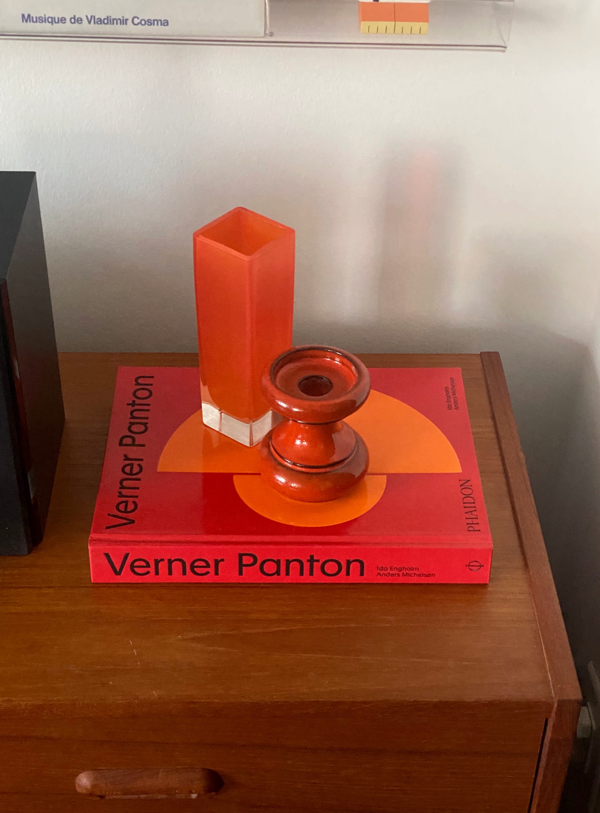 Orange objects on red-orange book.