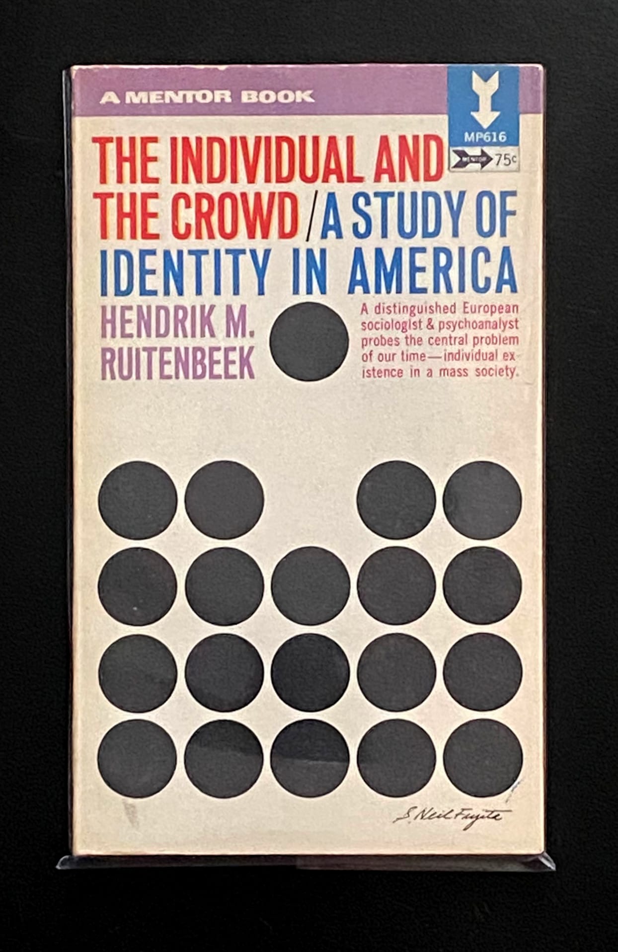 A paperback of "The Individual and the Crowd" featuring a grid of circles with one moved away from the rest.