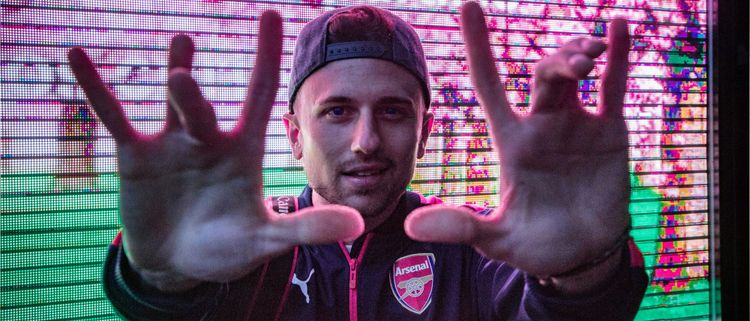 Trendy guy with his hands outstretched like a director framing a shot.