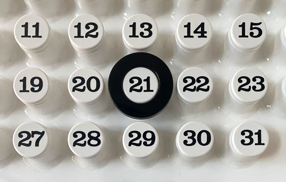Close up of Ring-A-Date calendar with ring around the number 21.