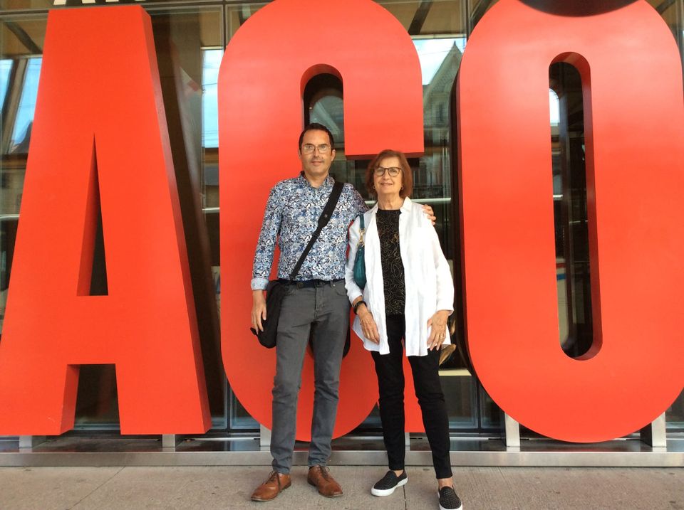 Letters spelling "AGO" in gigantic red type with my Mom and me standing in front.