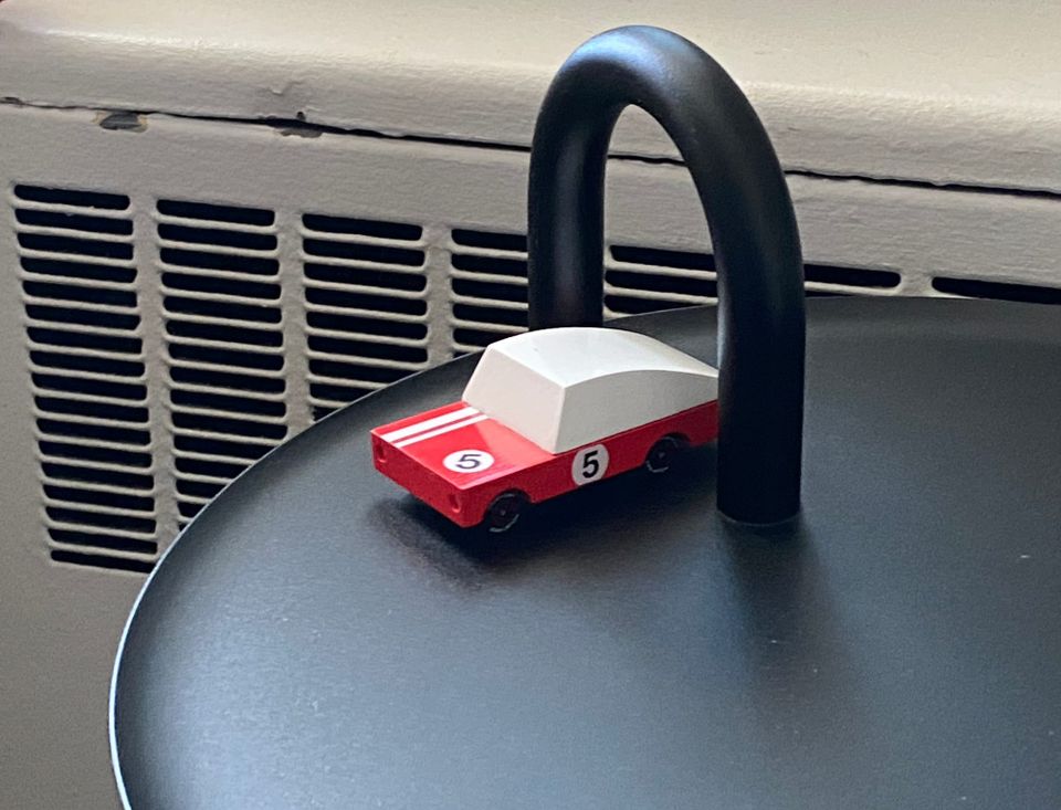 Toy race car on Bowler tabletop.