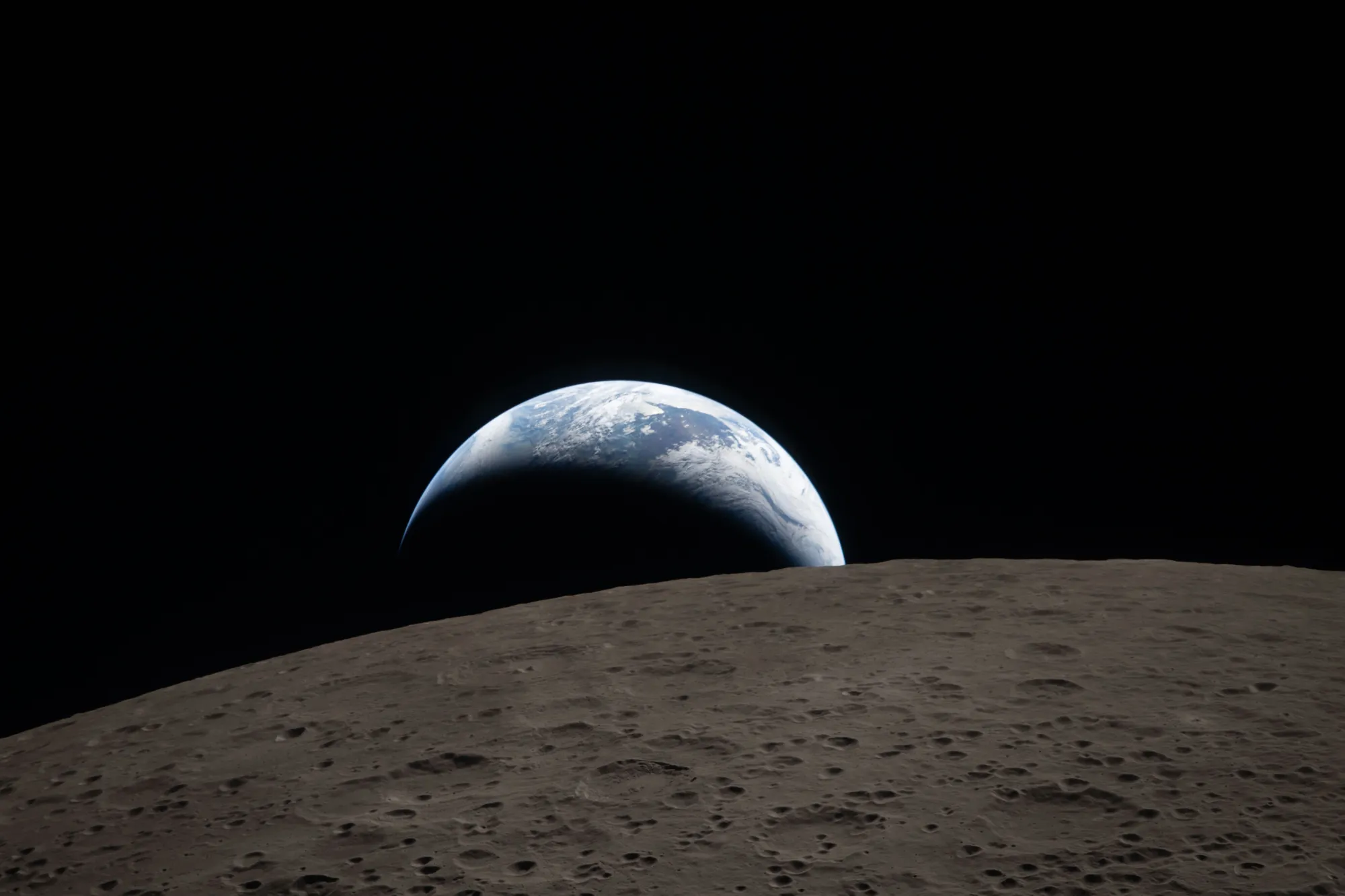 The image shows Earth rising over the Moon's cratered surface in space. A striking visual of Earth's blue and white hues against a black sky.