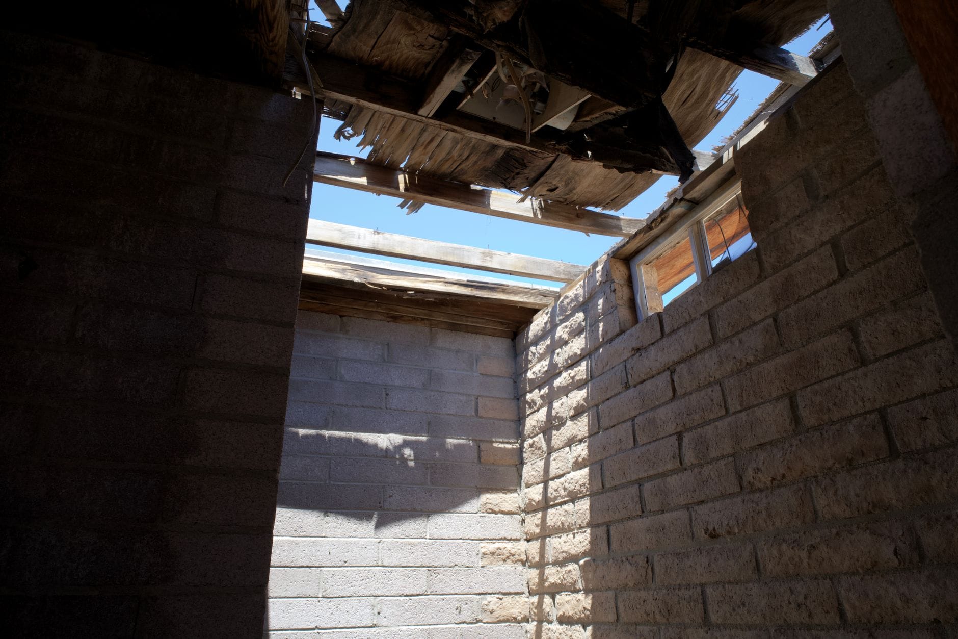 Damaged roof shingles showing wear, gaps, and areas needing repair