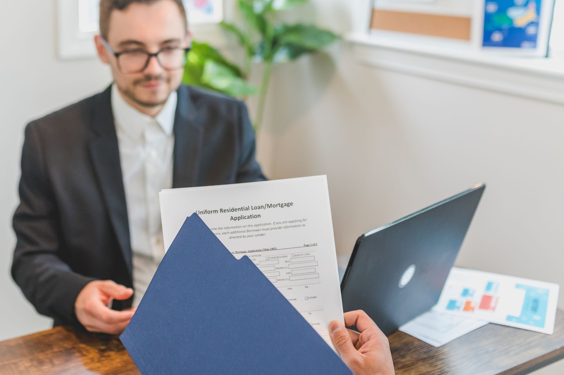 Mortgage approval letter and loan documents on desk