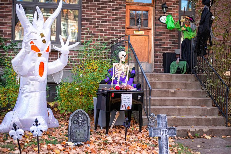 Elaborate Halloween yard display with glowing decorations and lawn ornaments