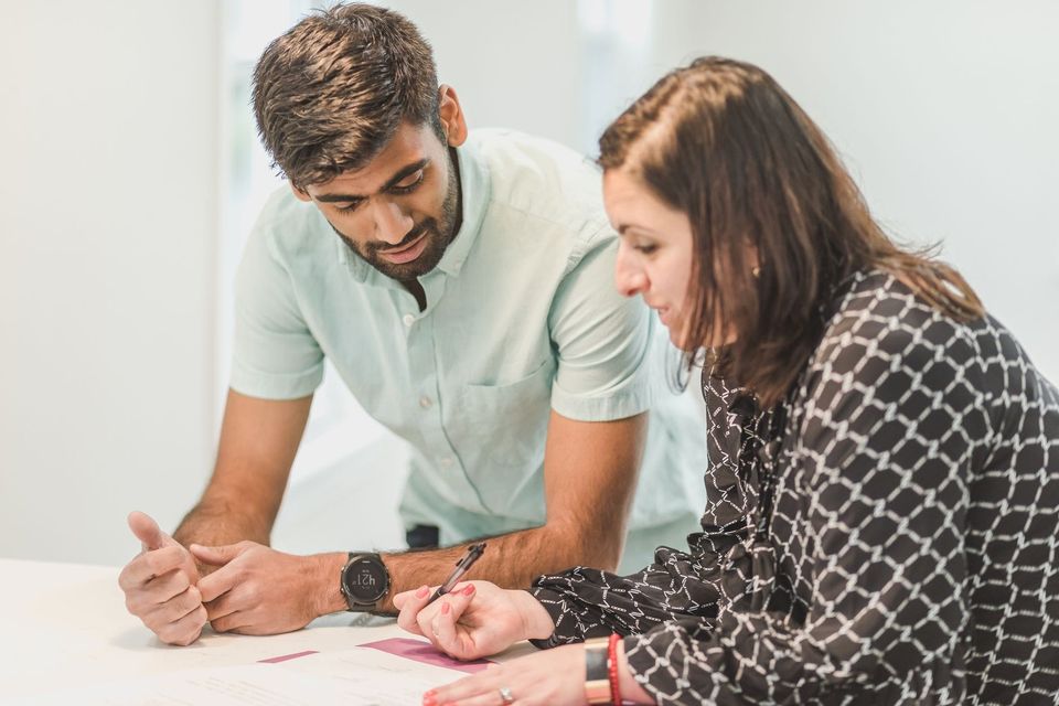 Real estate agent discussing paperwork with buyer at table