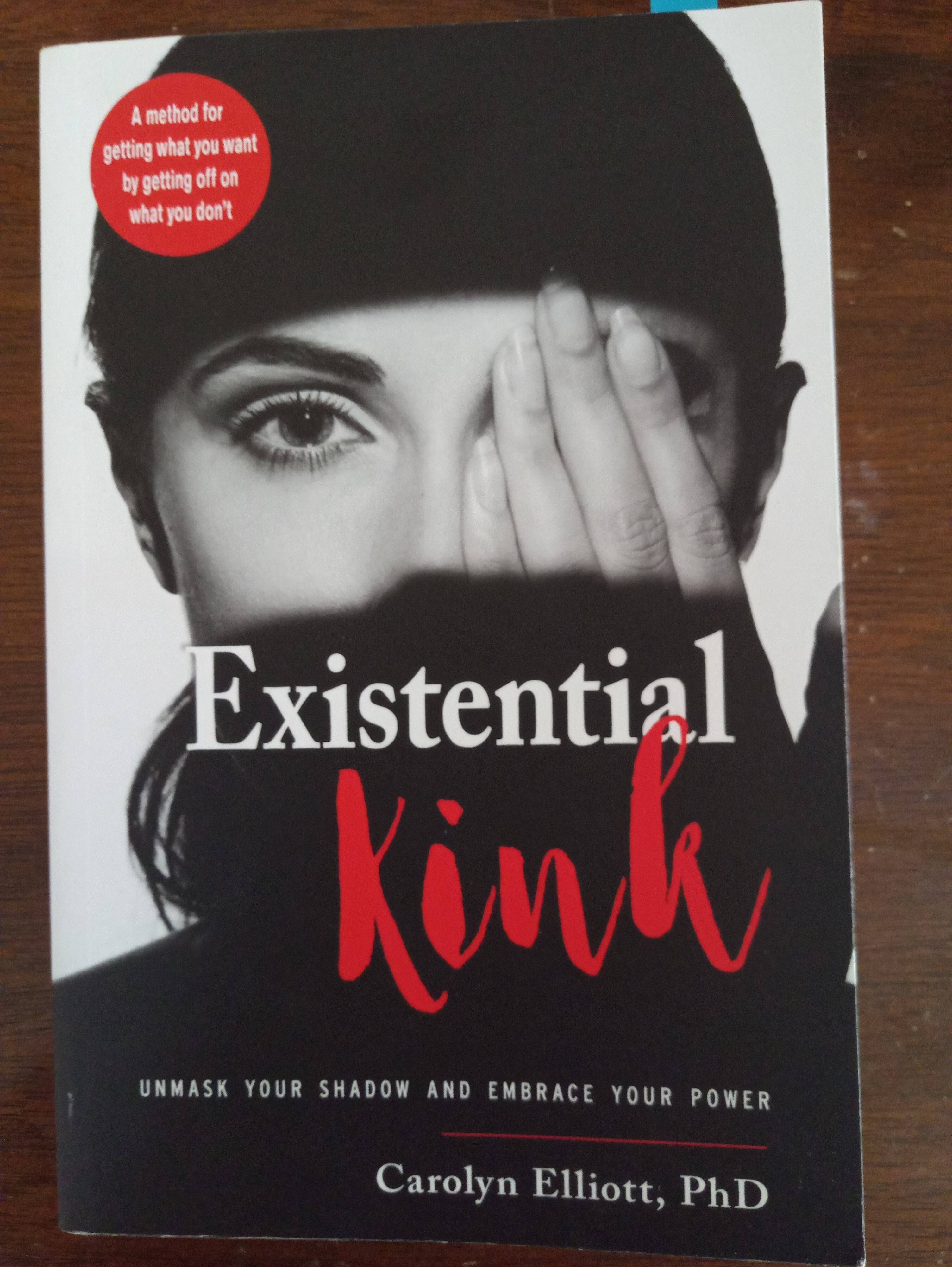 Image of person with hand covering one eye, book cover, title is Existential Kink: Unmask Your Shadow and Embrace Your Power Carolyn Elliott, PhD