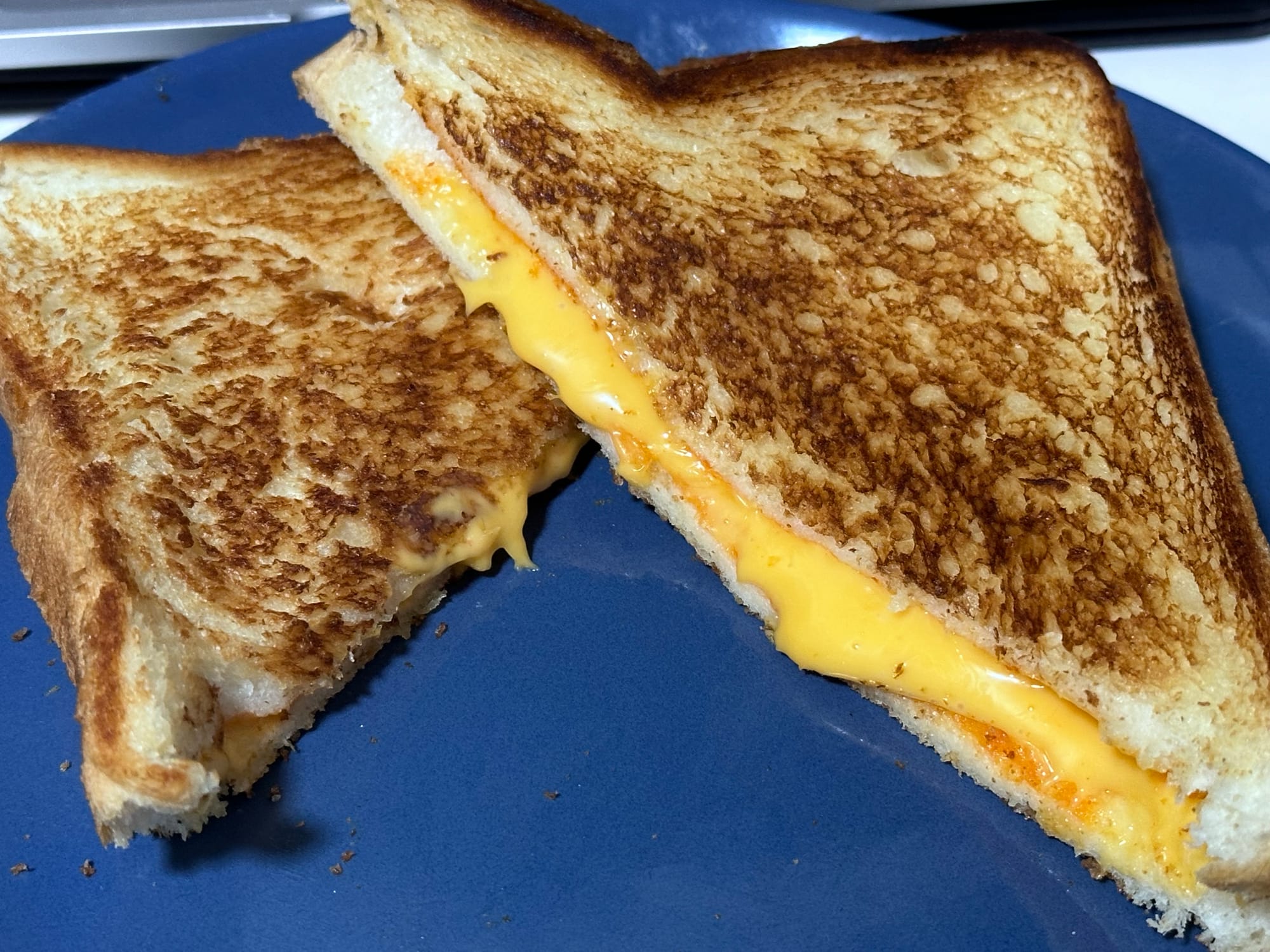 A succulent grilled cheese with plastic American cheese in the middle