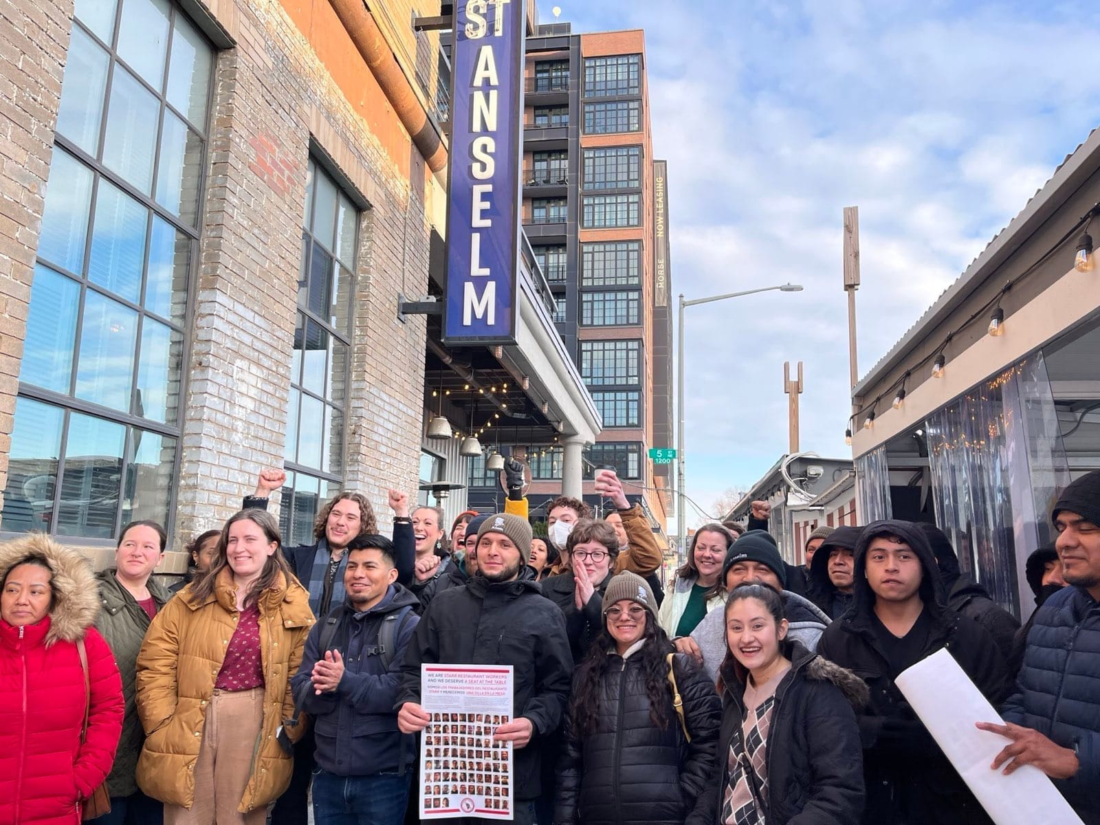 Photo showing approximately 20 people standing in front of St. Anselm.