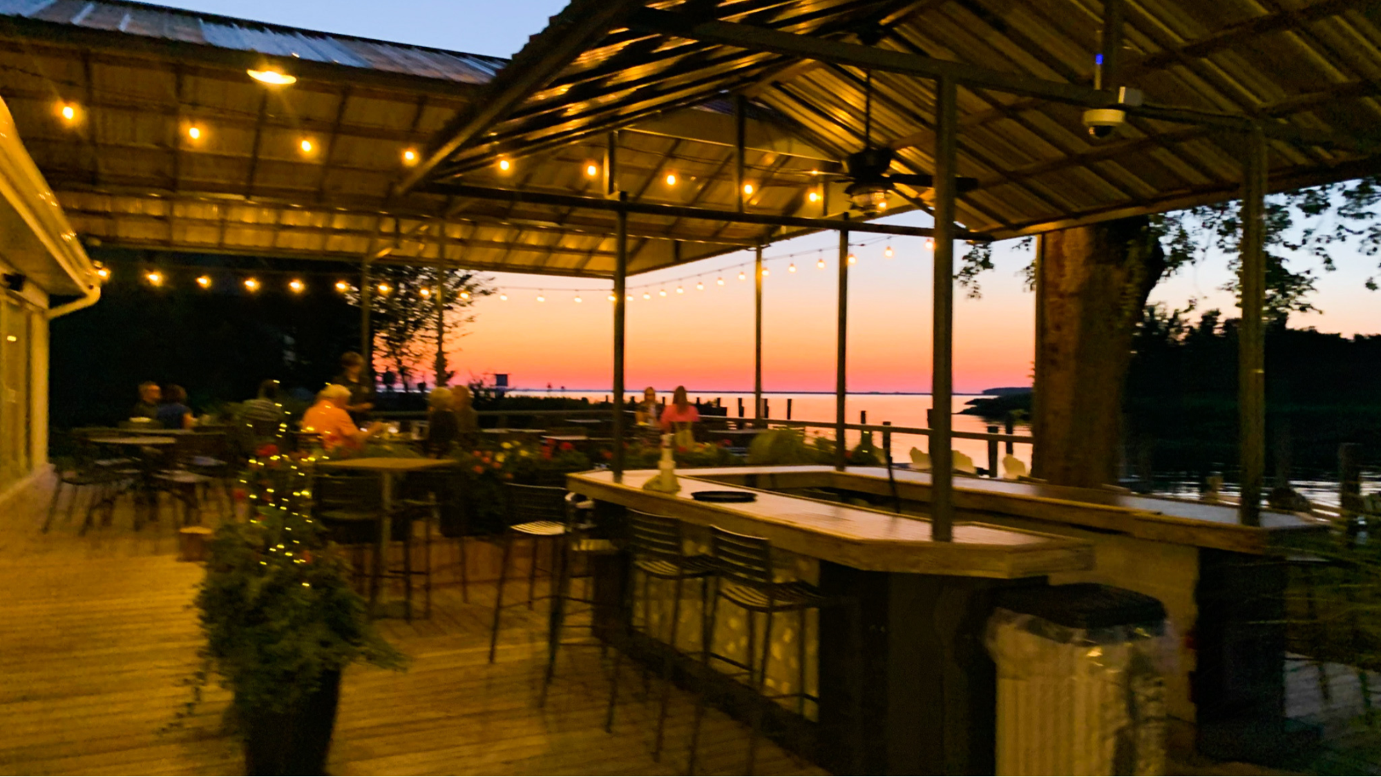 A view of an outdoor bar at sunset at the Tilghman Island Inn.