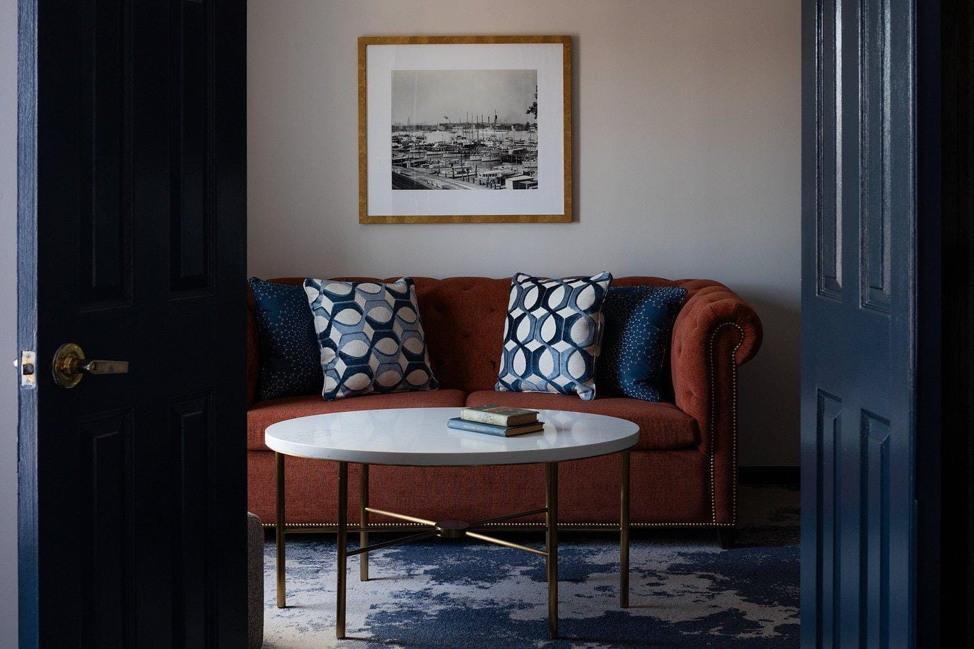 A photo of a couch and table in a hotel room 