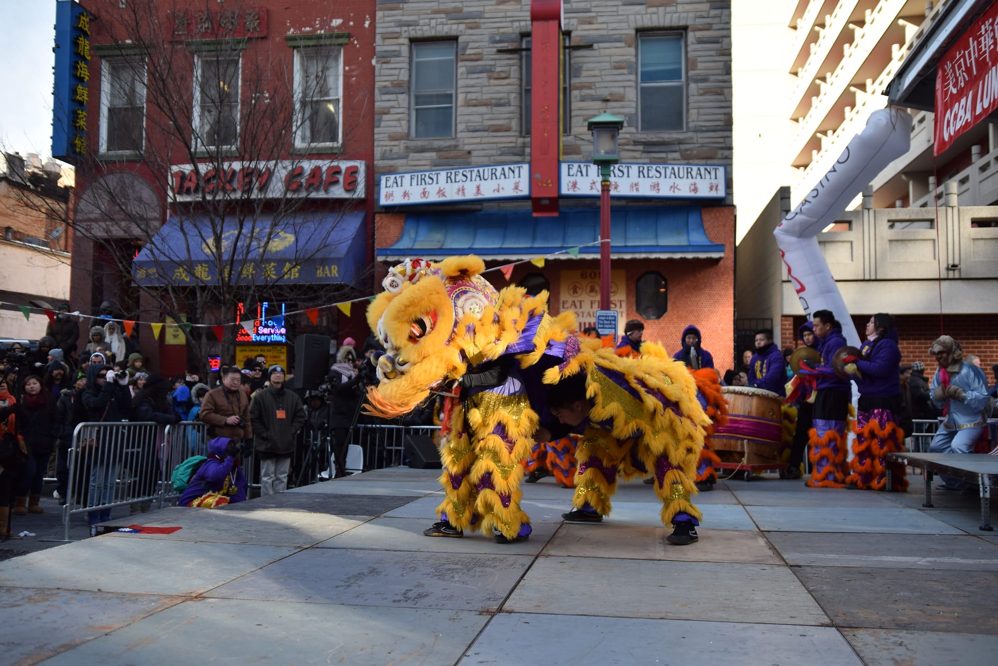 A photo of a dragon costume during a Chinese New Year celebration in Chinatown D.C. Jackey Cafe is visible in the background. 