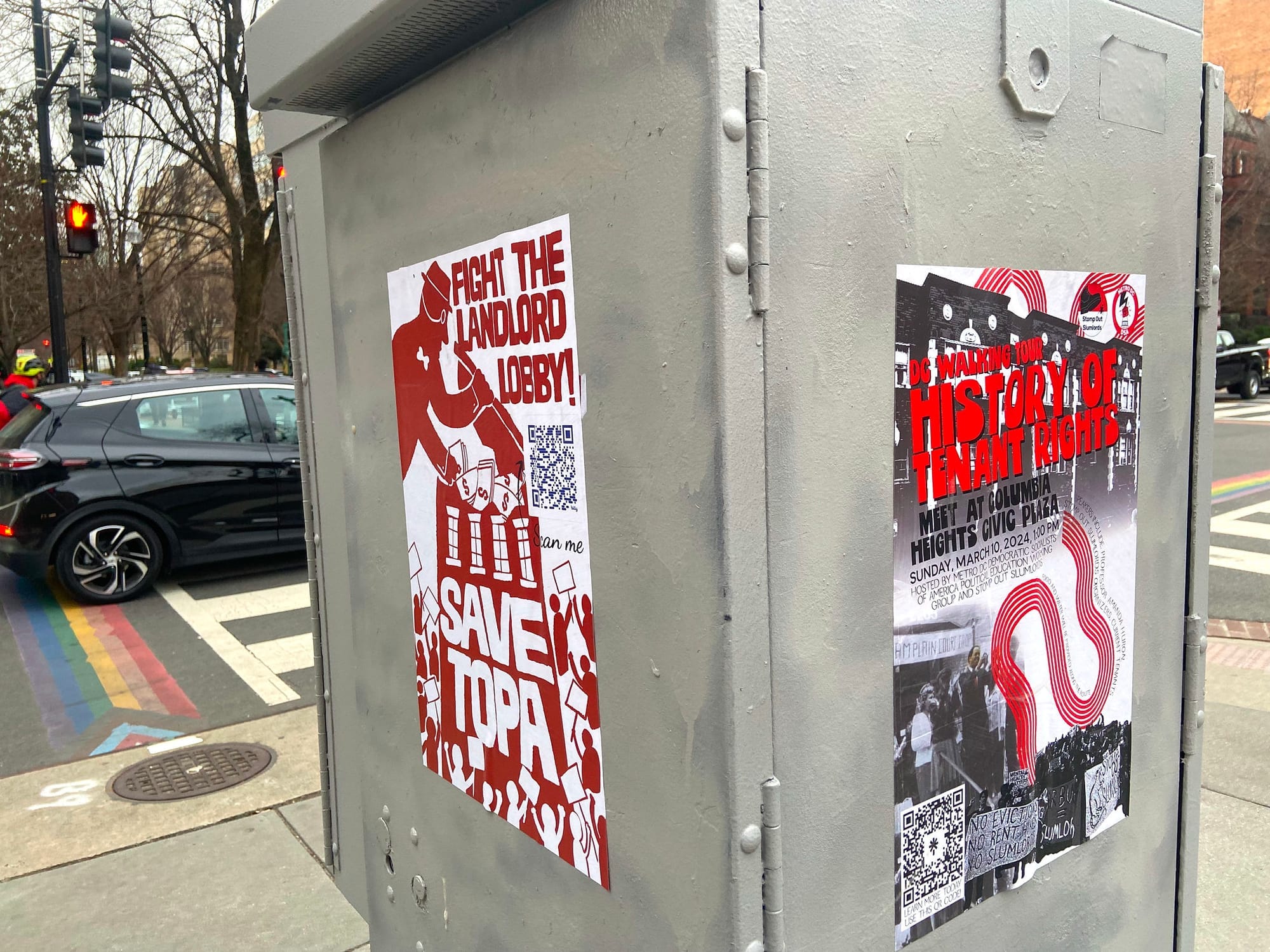 Wheatpasted red and white posters that read RIGHT THE LANDLORD LOBBY and SAVE TOPA.