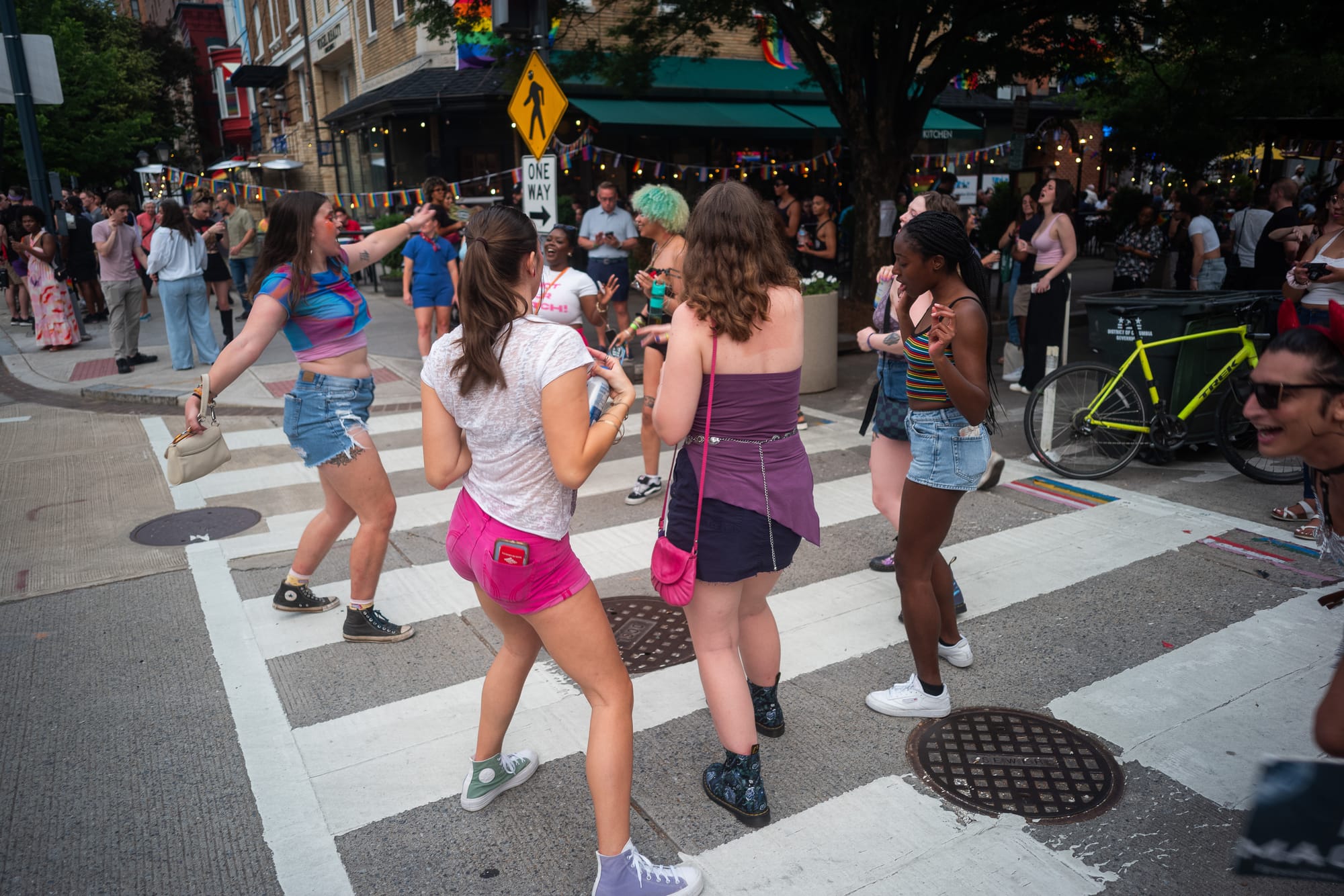 A group of people dancing in a crosswalk. 