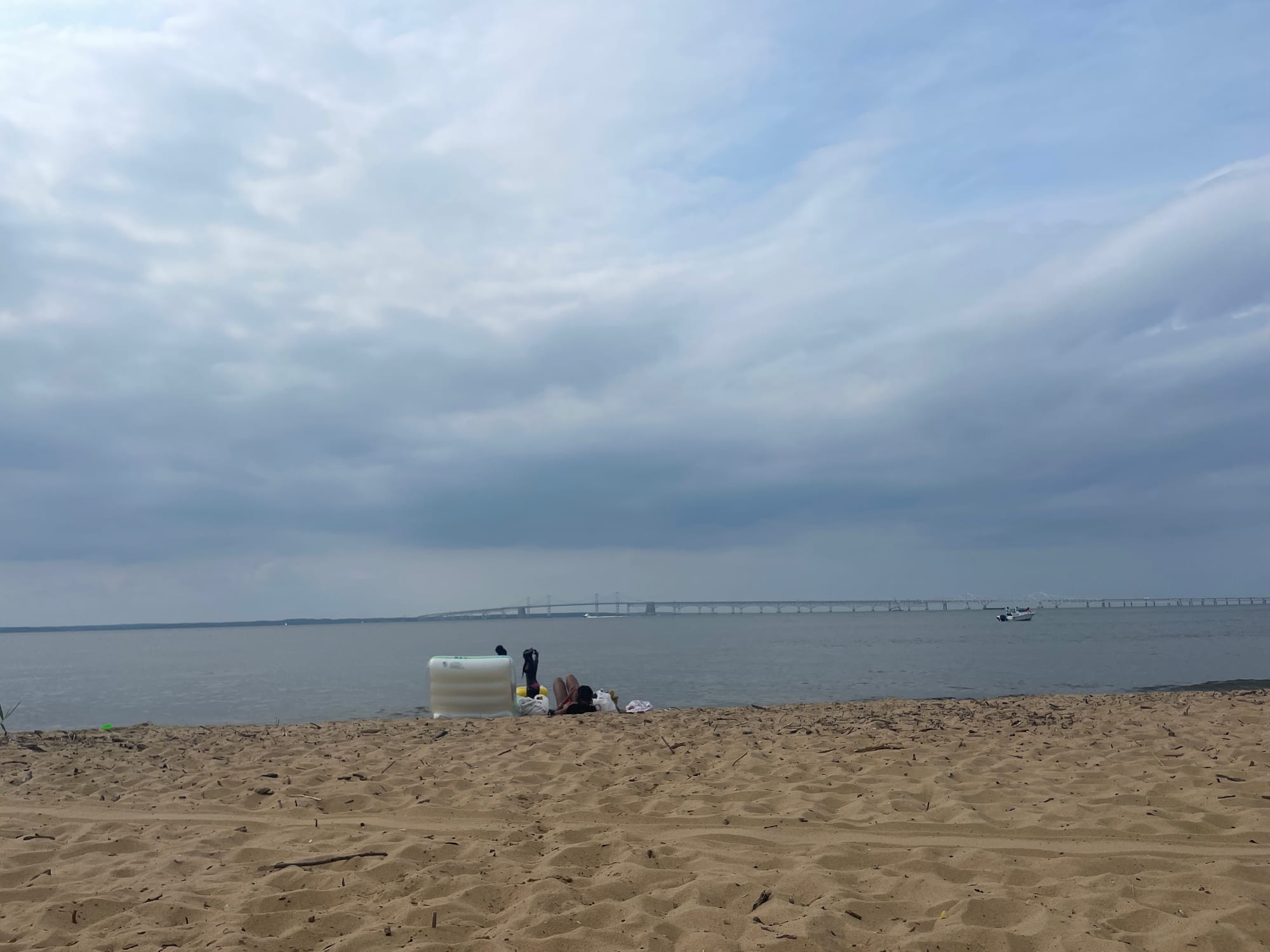 A shoreline with a bridge in the foreground