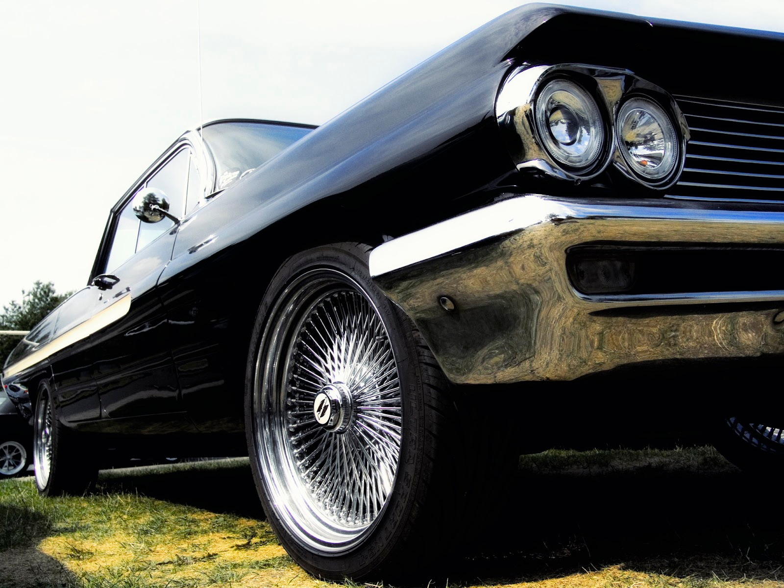 A shiny black lowrider car