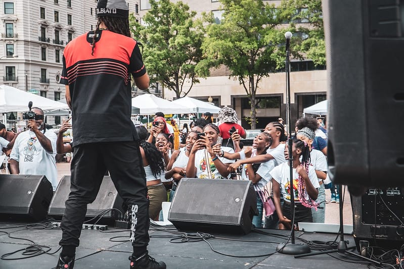 A group of young Black women attend a concert in D.C.'s Freedom Plaza
