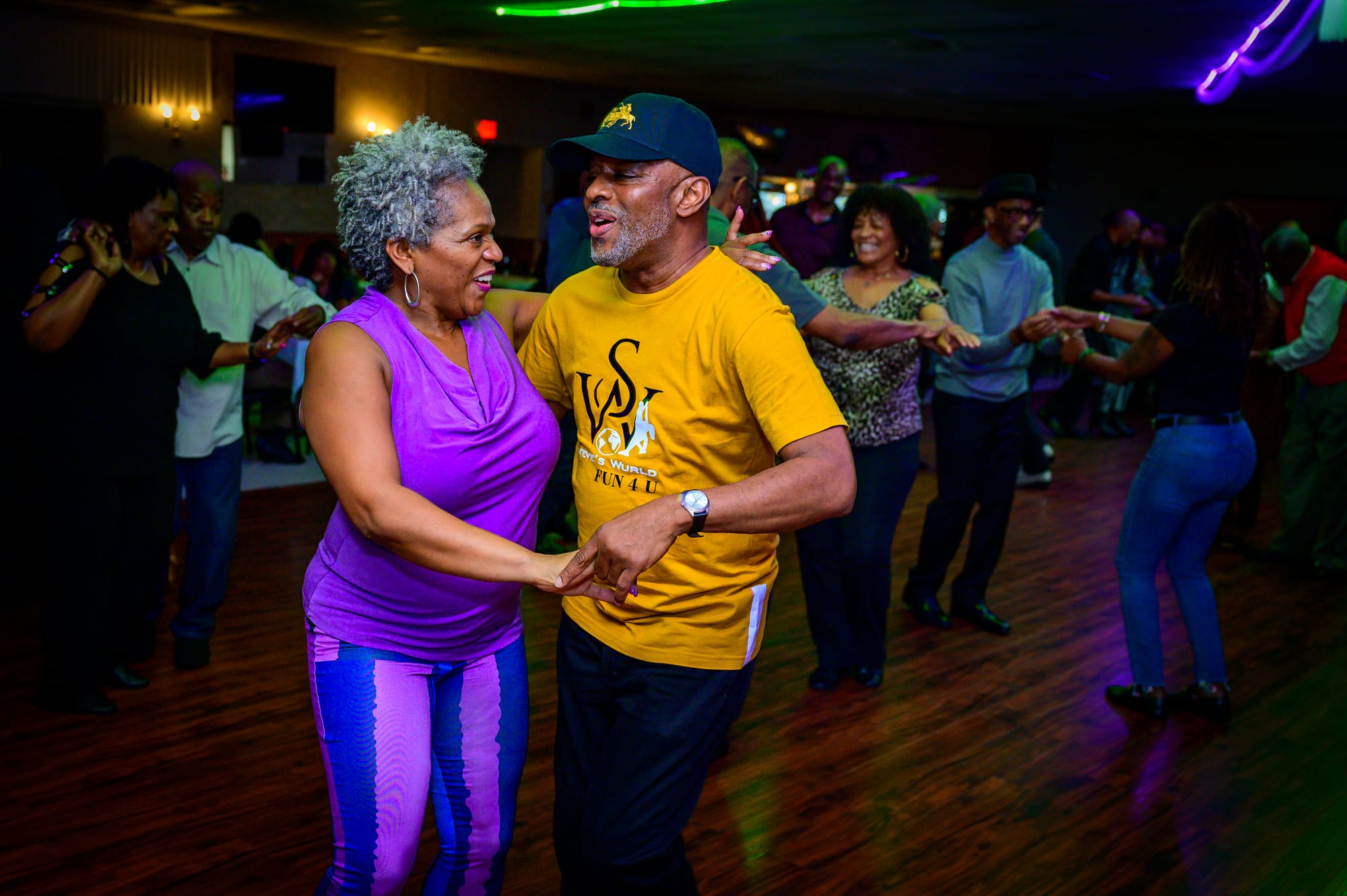 A photograph of two people dancing on a dance floor.