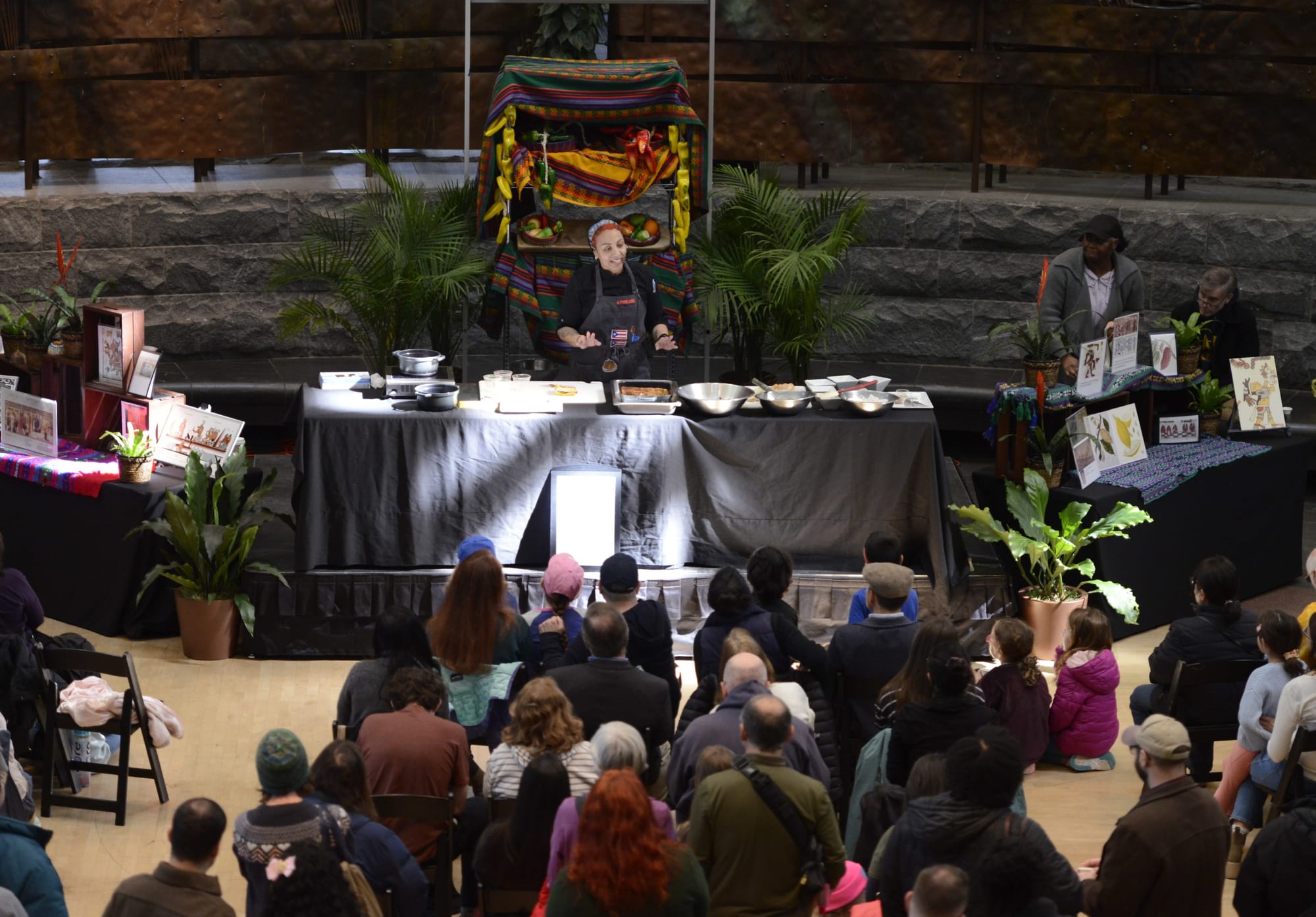 A person leads a cooking demonstration at a museum.