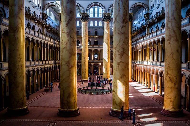 The majestic atrium of D.C.'s National Building Museum, with light streaming in.