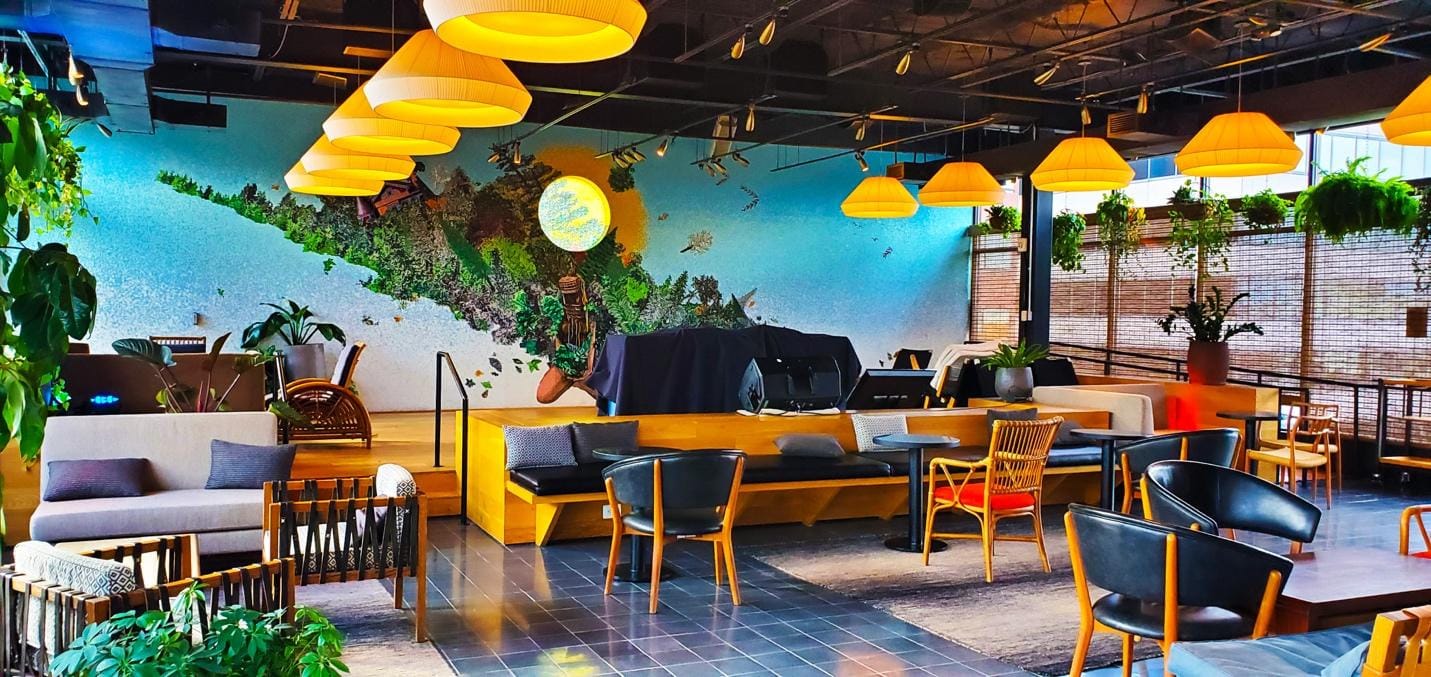 A room with a wall mural and a table and chairs

AI-generated content may be incorrect.