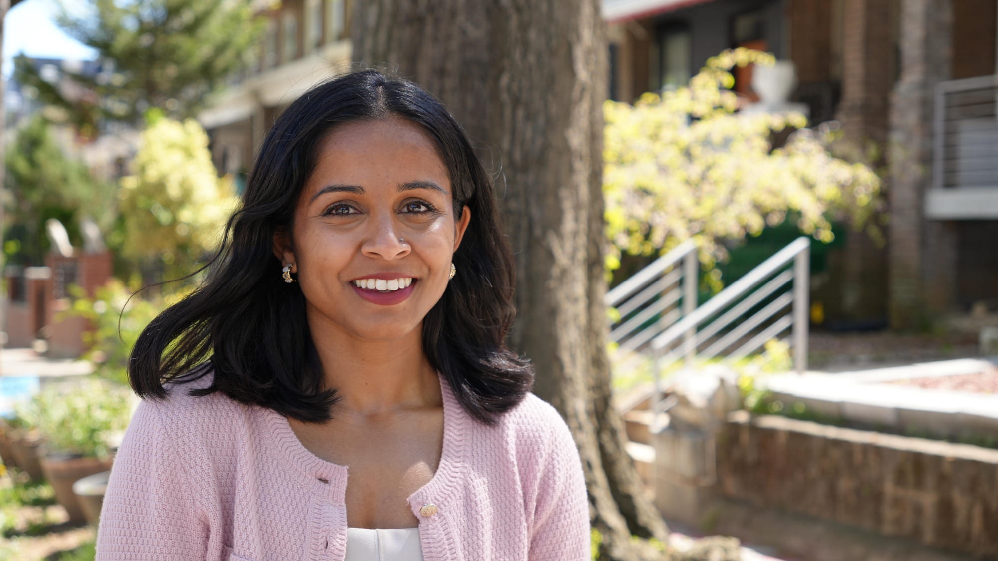 A photo of Aparna Raj standing outside a street in Ward 1.