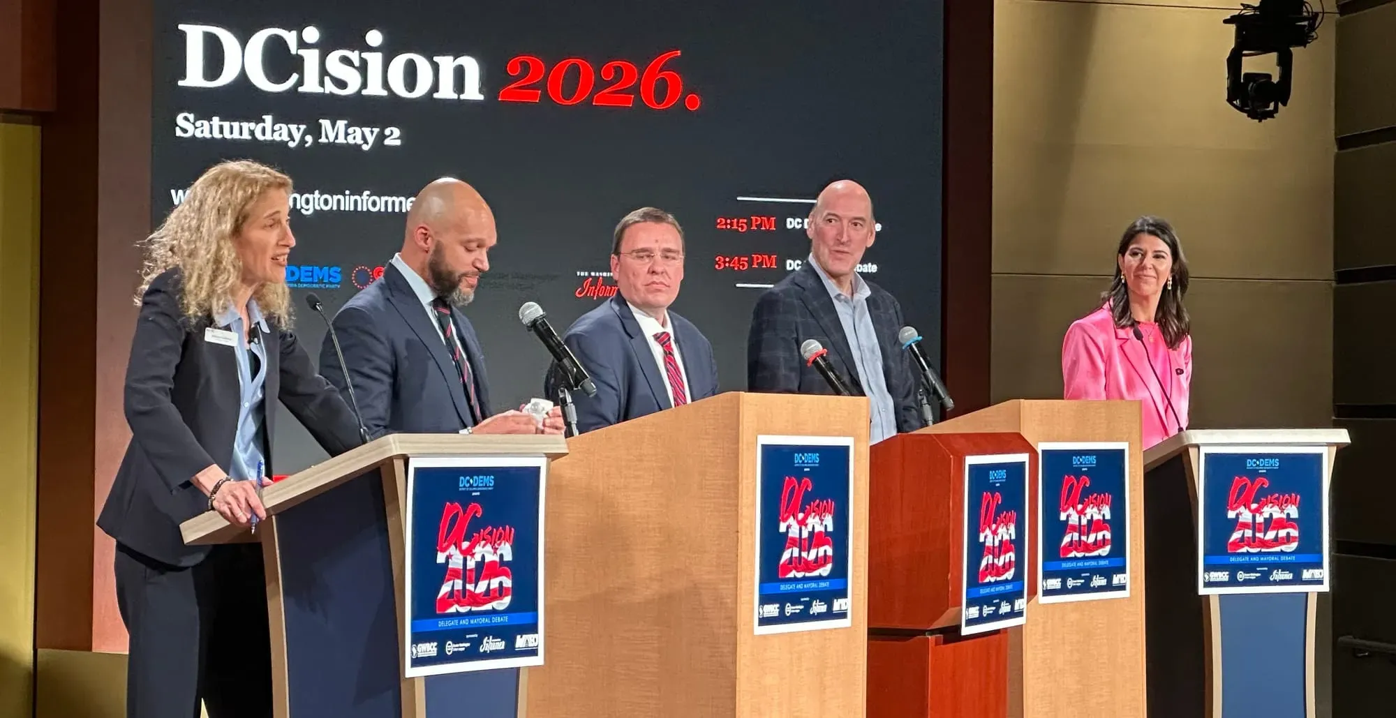 The candidates for D.C.'s delegate to congress are lined up behind podiums