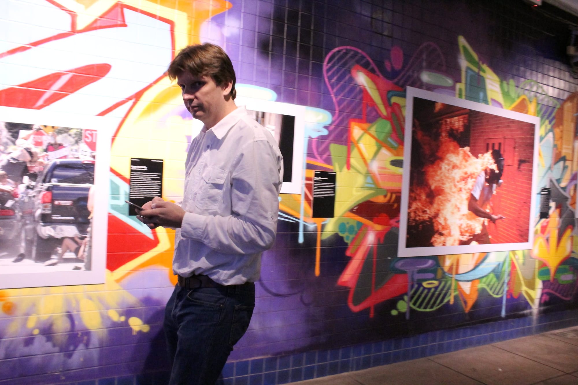 A photography exhibit on top of graffiti-decorated walls in Washington, D.C.'s Dupont Underground